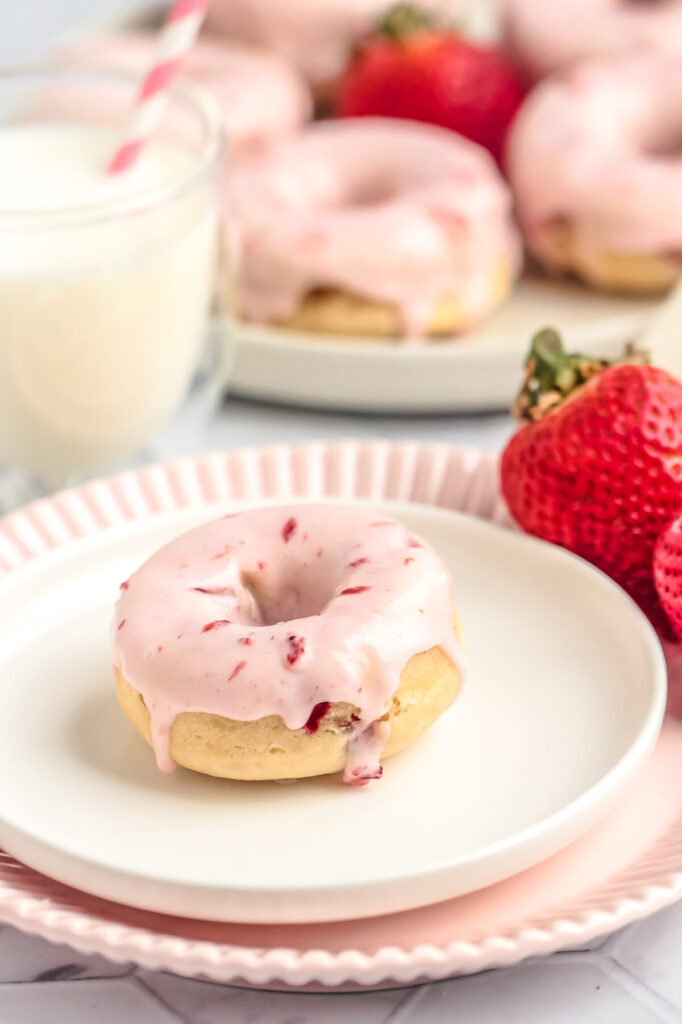 This Baked Strawberry Donuts recipe makes moist and fluffy donuts packed with fresh strawberries, topped off with a fresh strawberry glaze!