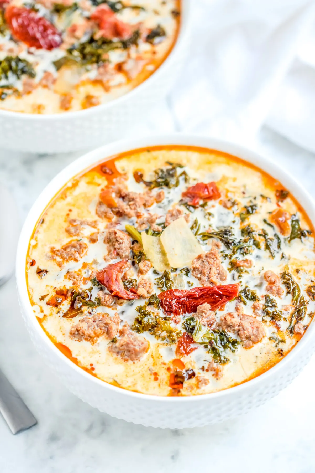 This Keto Tuscan soup recipe is a low carb take on the classic zuppa toscana. It's hearty, creamy, full of flavour and made in just one-pot!