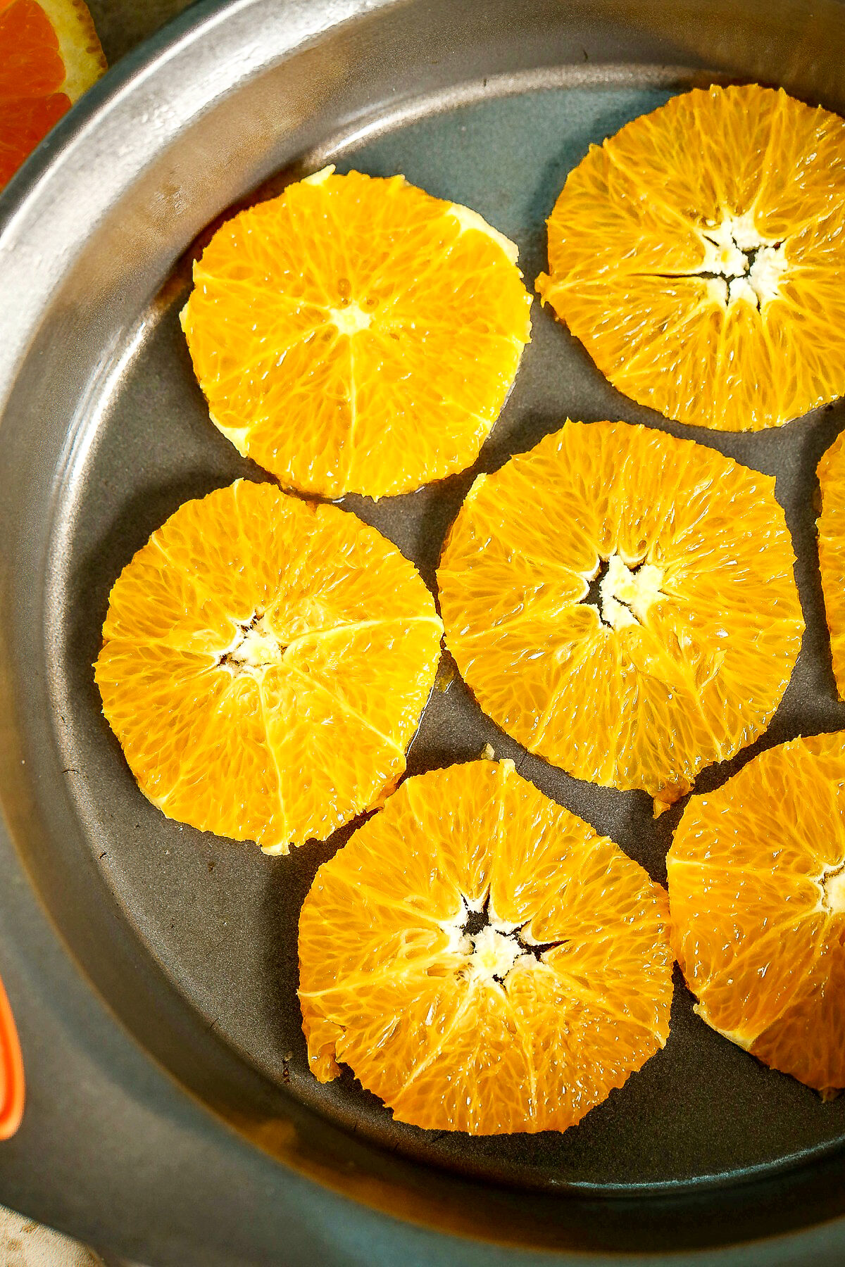 Orange slices at bottom of cake pan.
