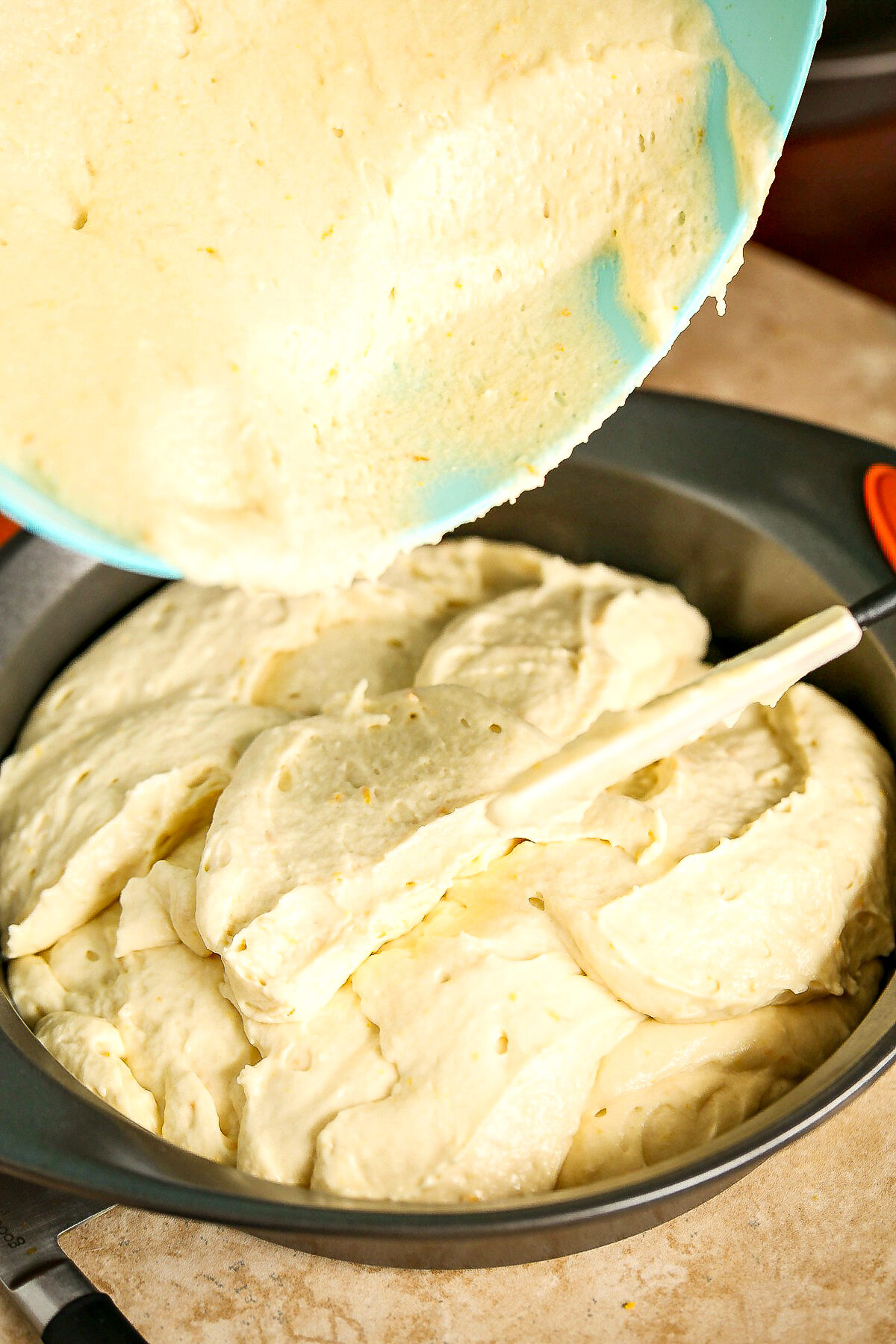 Pouring batter into the cake pan.