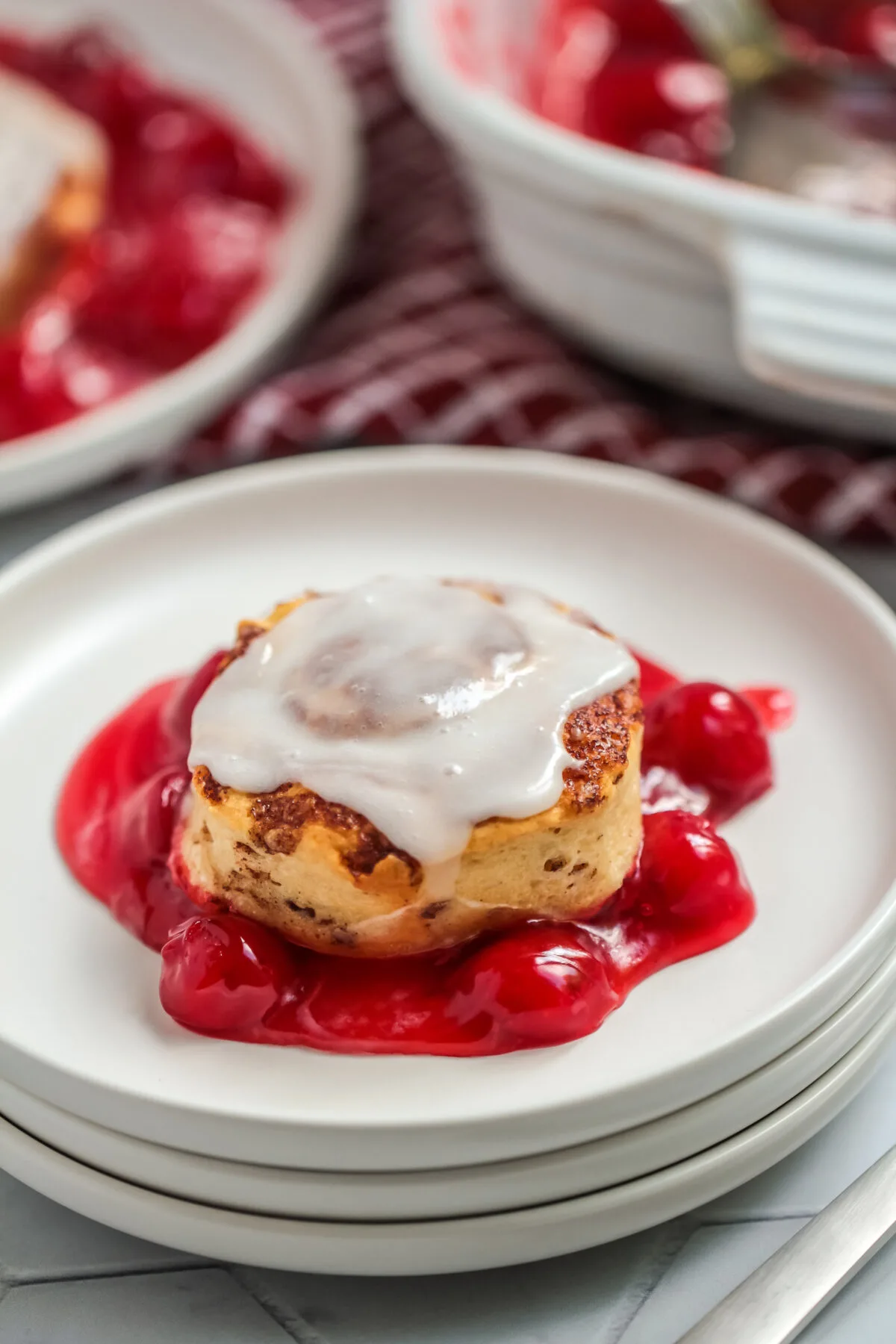This Cinnamon Roll Cherry Cobbler Recipe uses just two ingredients. Warm and gooey, this easy dessert is perfect for any occasion.
