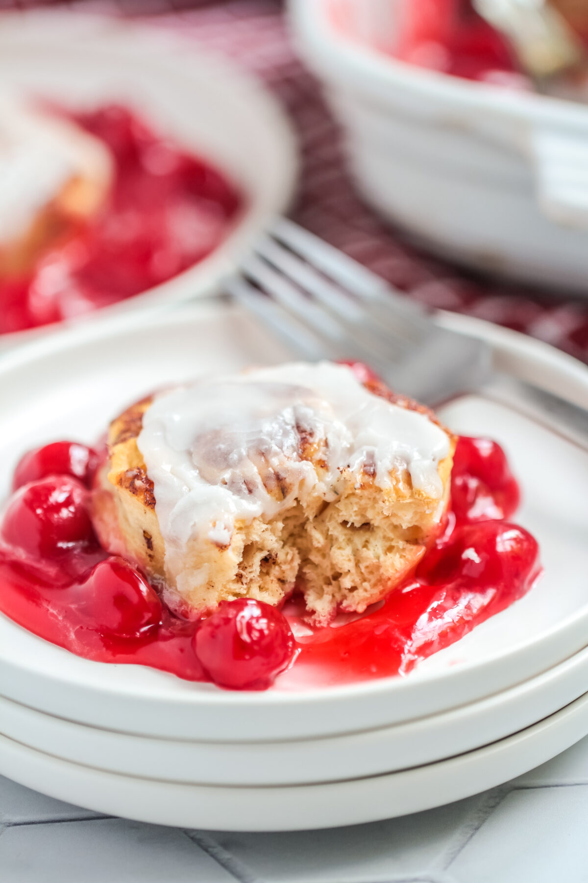 This Cinnamon Roll Cherry Cobbler Recipe uses just two ingredients. Warm and gooey, this easy dessert is perfect for any occasion.