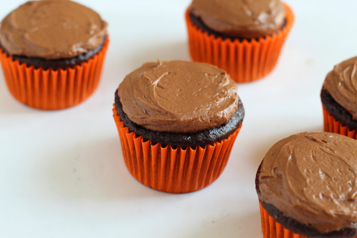 Chocolate cupcakes with a little frosting on top.