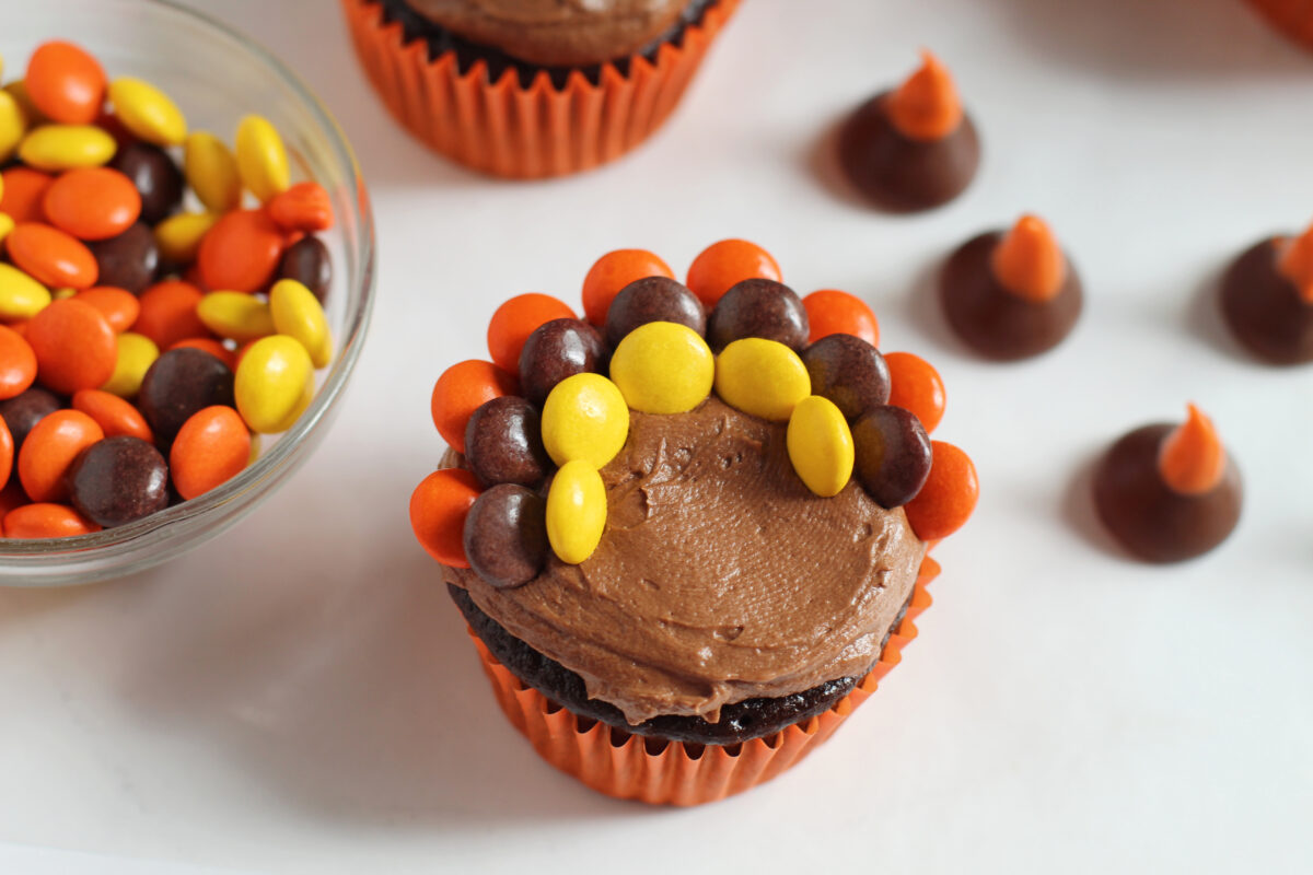 Reese's pieces placed in the frosting to make turkey feathers.