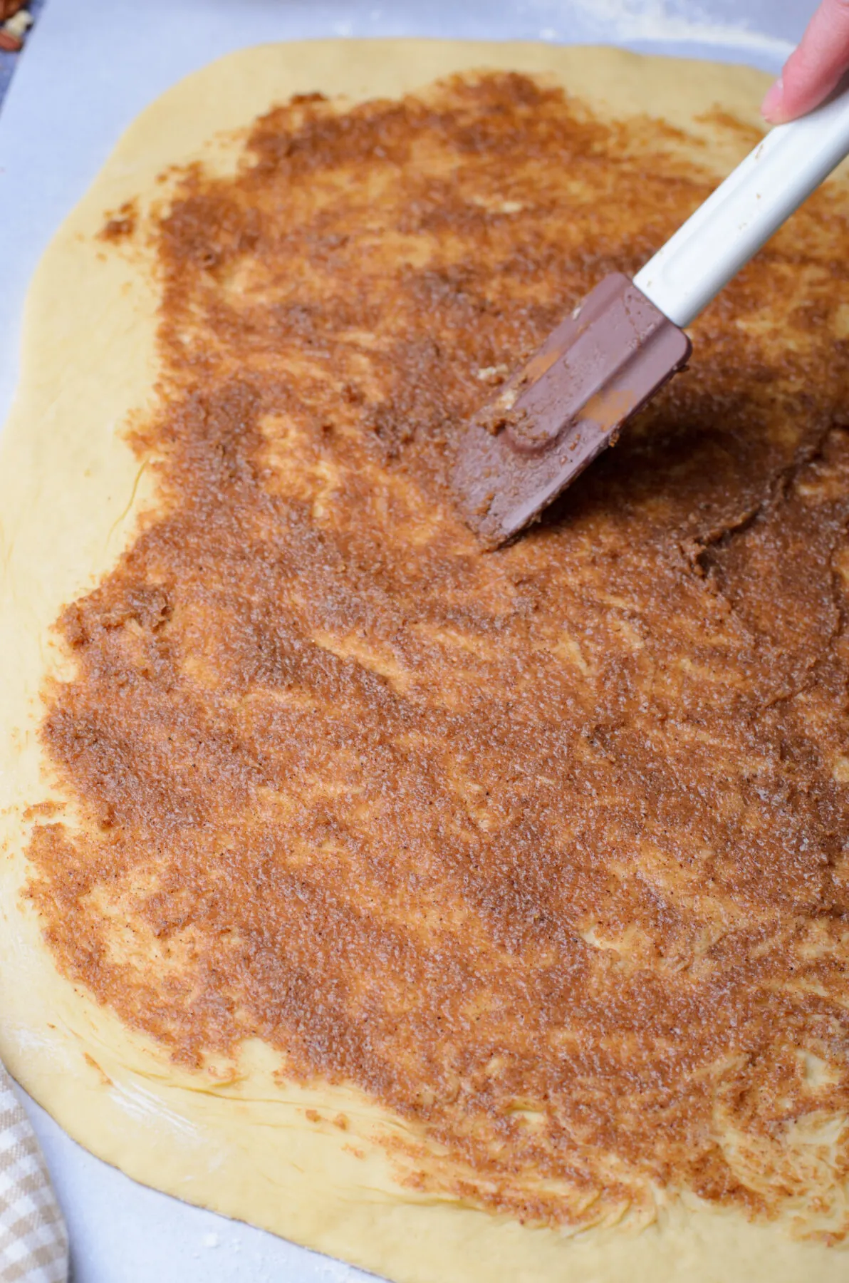 Cinnamon butter spread out on the dough.