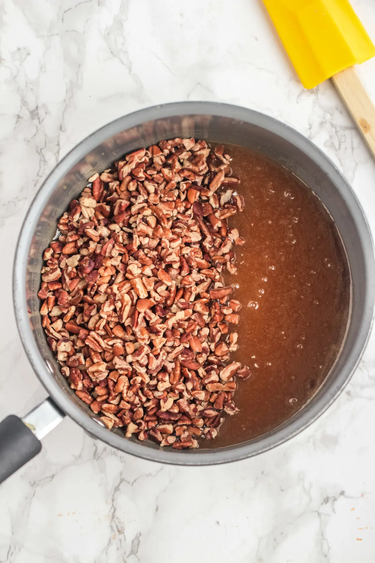 pecans being added to syrup.