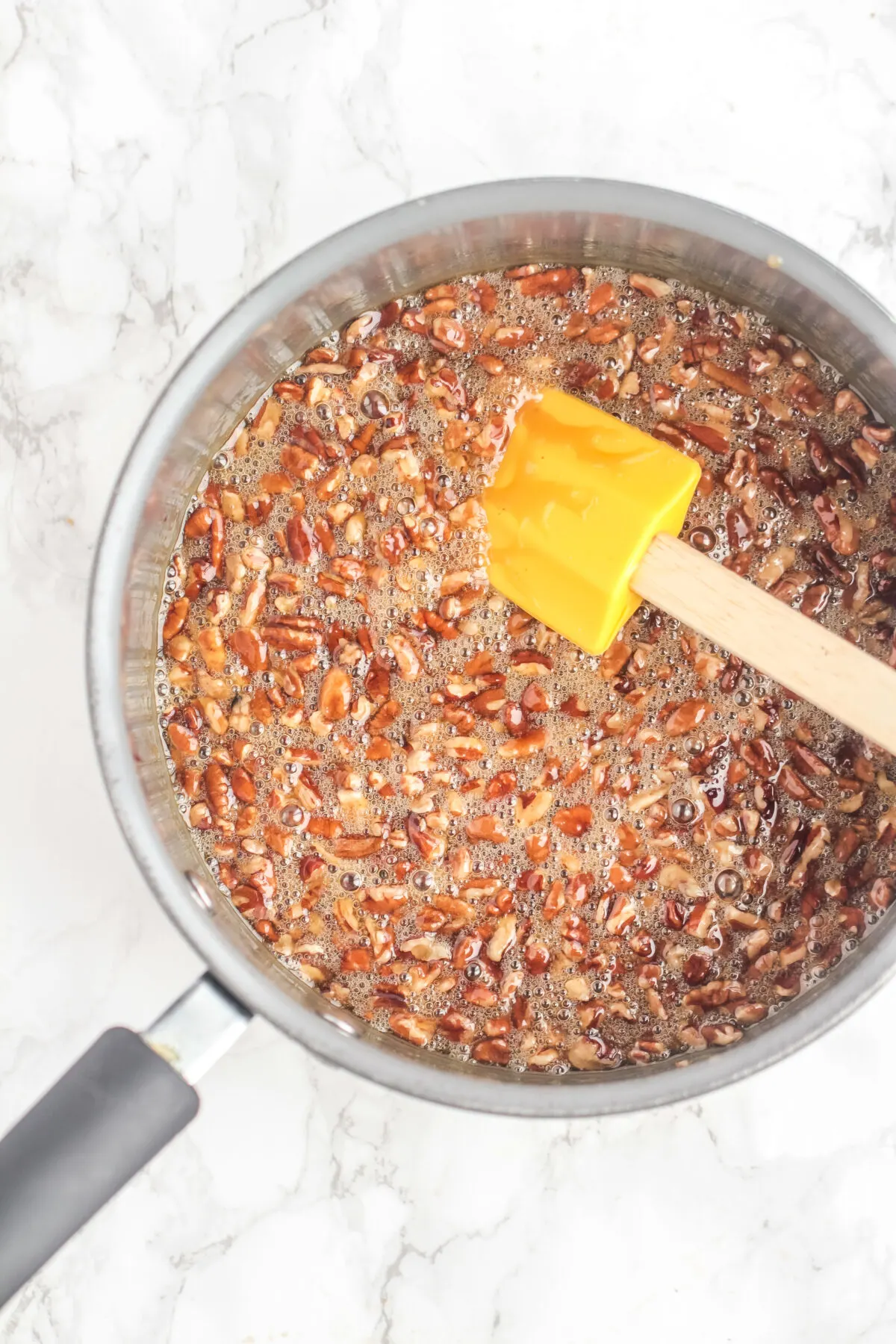 Pecans being stirred into the filling.