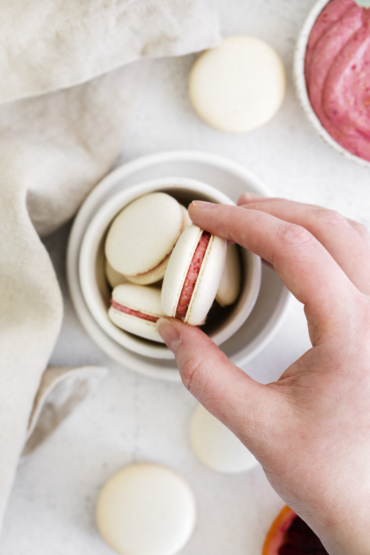 This Blood Orange Macarons recipe is sweet & chewy with a tangy citrus flavour; they're sure to be the star of the show at any holiday party.