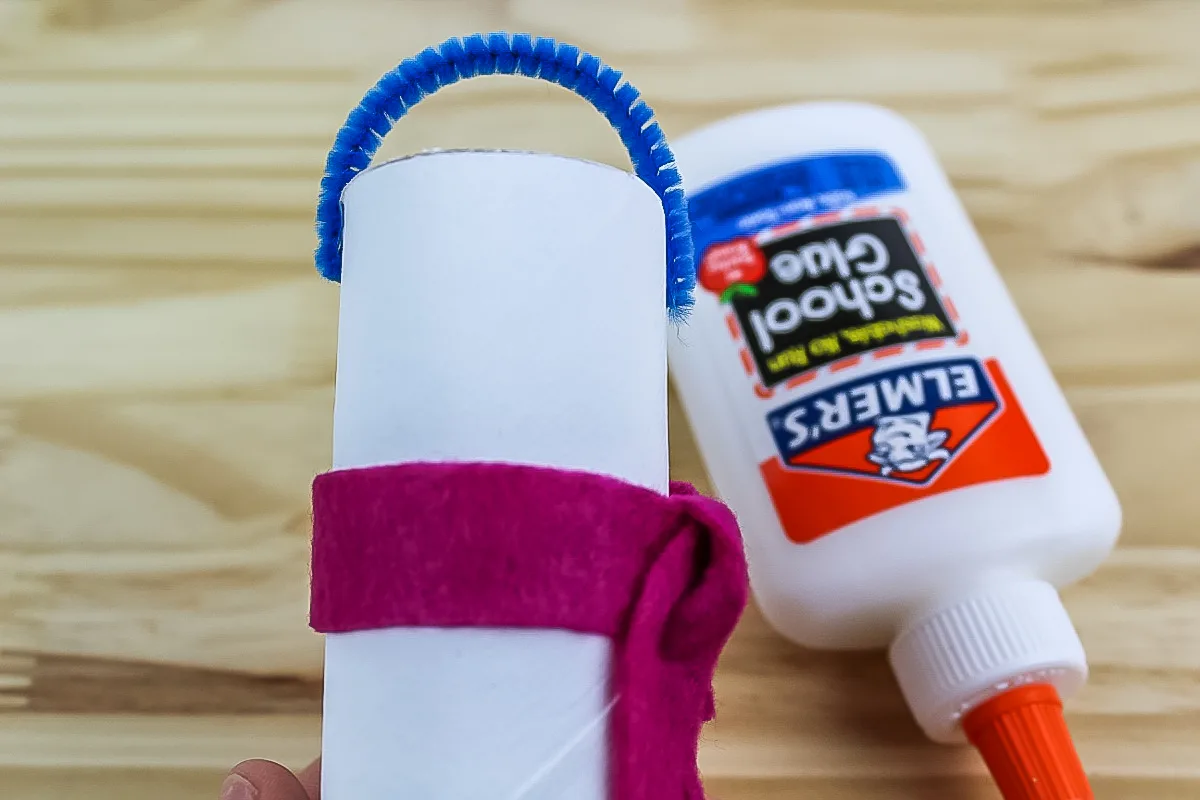 pipe cleaner glued to the stop of the tp roll