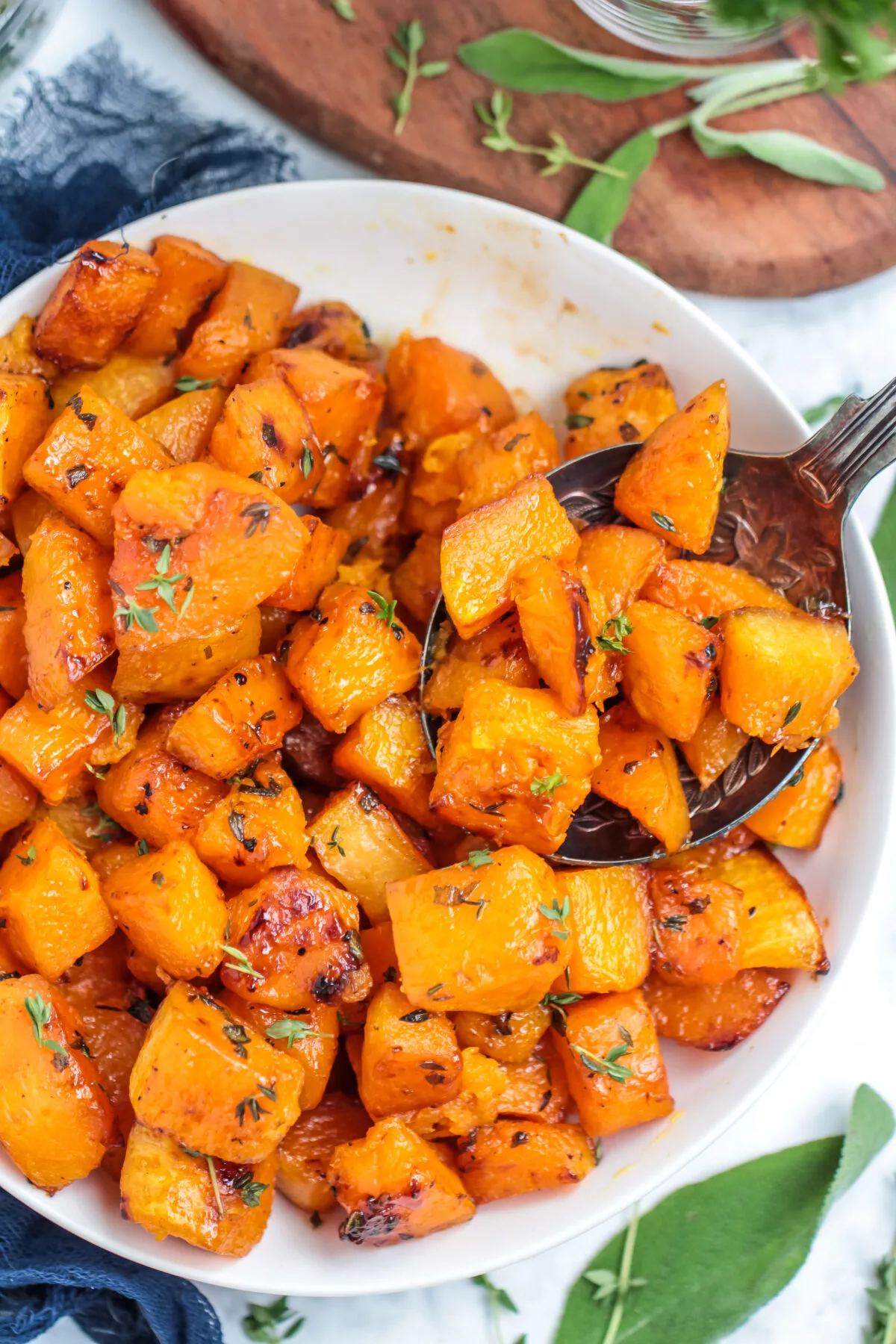 Roasted butternut squash with brown sugar and herbs is a tasty side dish for any fall menu. You will love this perfectly caramelized squash!