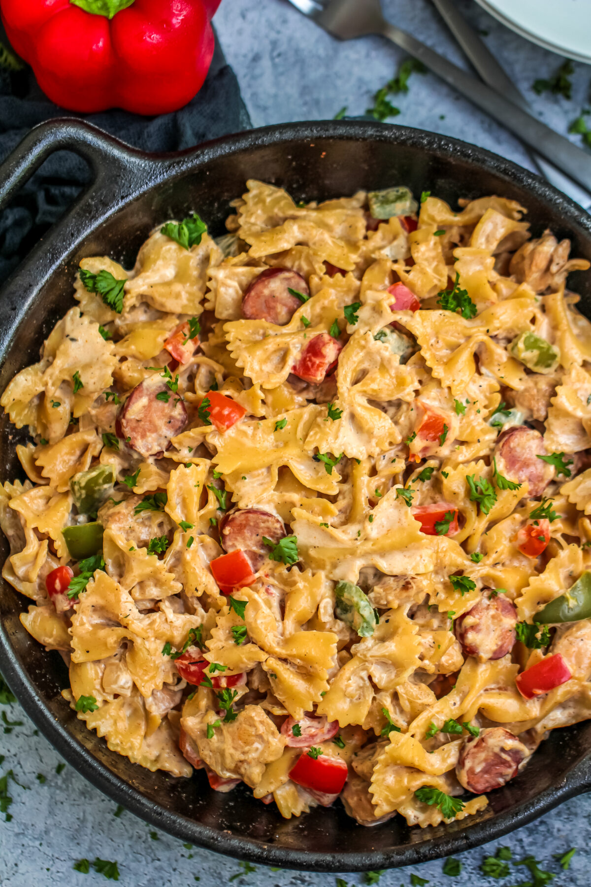This Cajun Chicken Alfredo Pasta Recipe is a spicy take on a creamy classic. The best of both worlds in one easy dish with Andouille sausage!