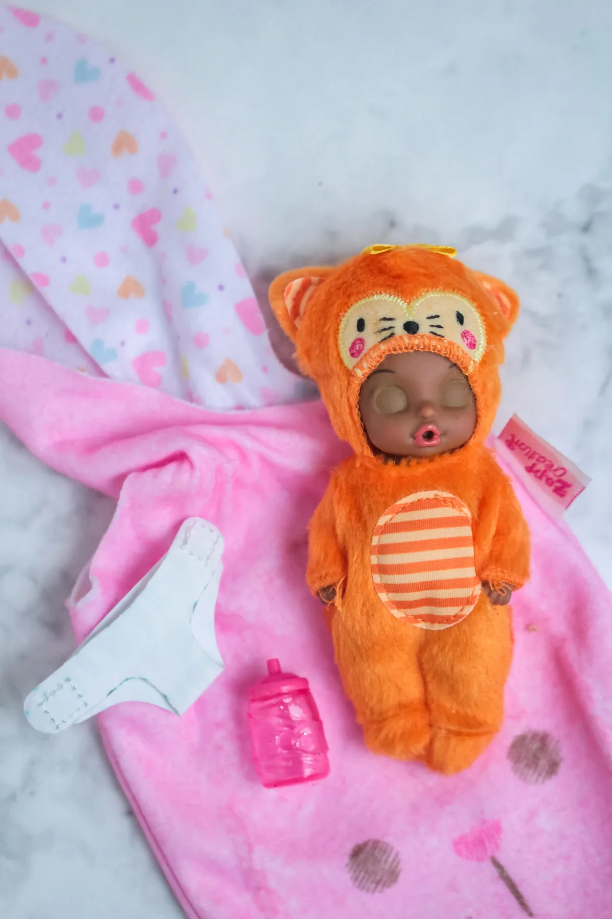 Baby Born Surprise Animal Babies are collectible baby dolls wearing soft and cozy themed onesies that come hidden inside a soft bunny pouch.