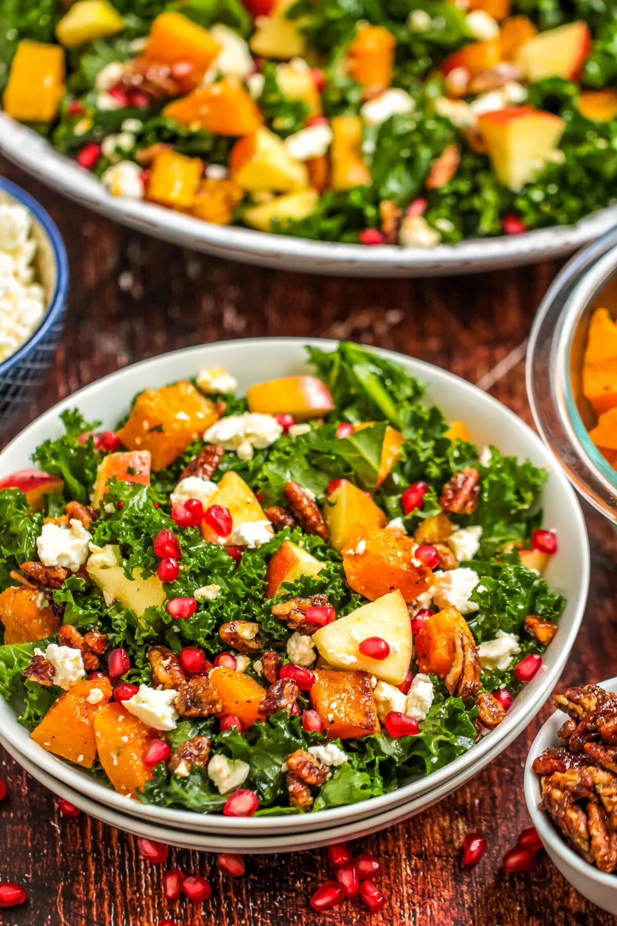 A beautiful salad that's perfect for fall, this Roasted Butternut Squash & Apple Salad recipe features candied pecans and feta cheese.