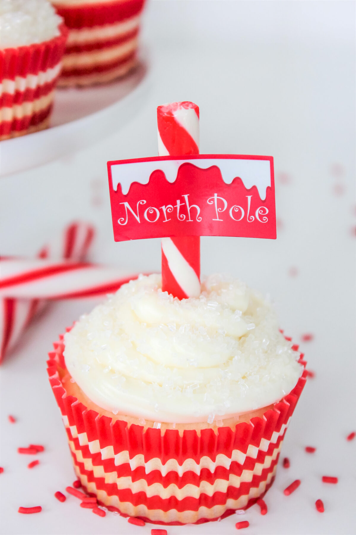 These sugar cookie North Pole cupcakes topped with a cute printable topper and candy cane are the perfect festive holiday treat for kids.