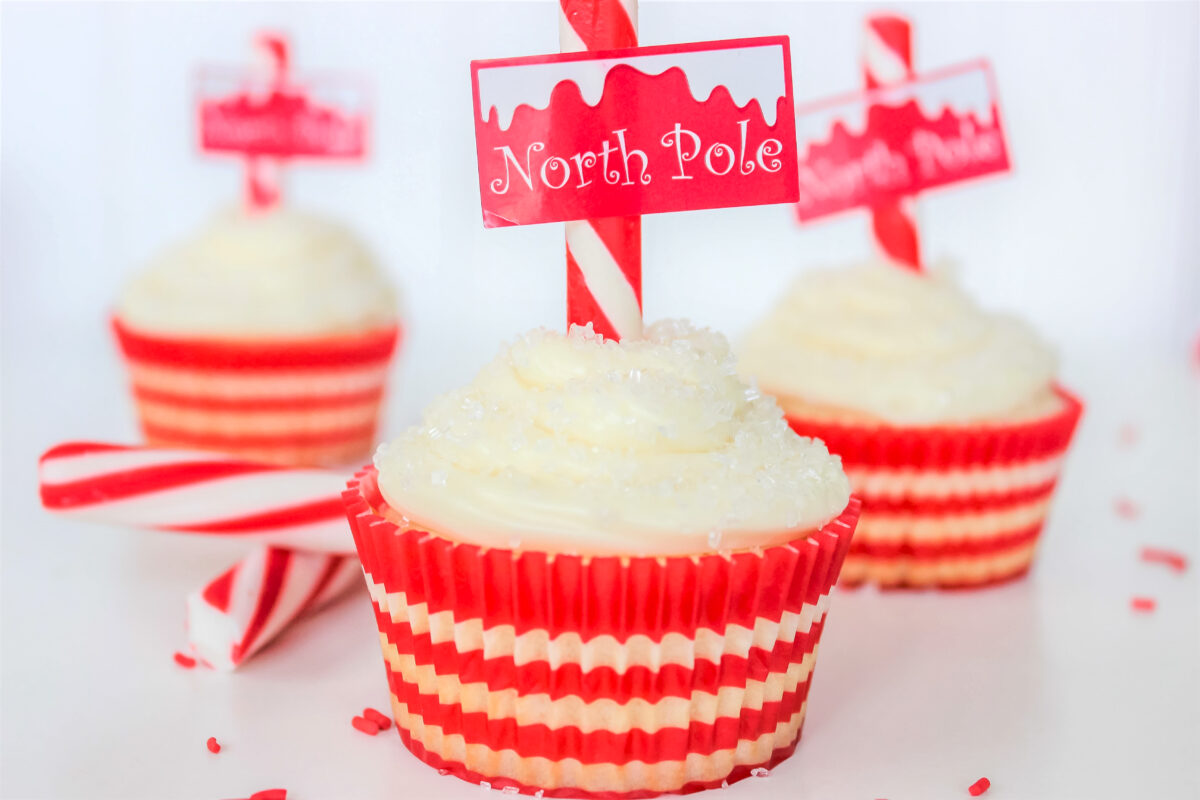 These sugar cookie North Pole cupcakes topped with a cute printable topper and candy cane are the perfect festive holiday treat for kids.