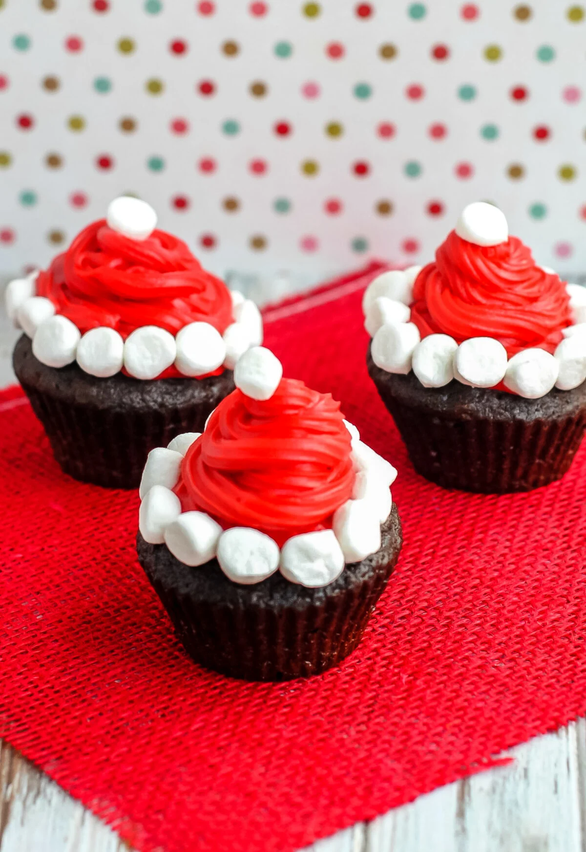These Santa hat cupcakes are easy to make, cute as can be and sure to please the kids. A fun holiday treat for Christmas!