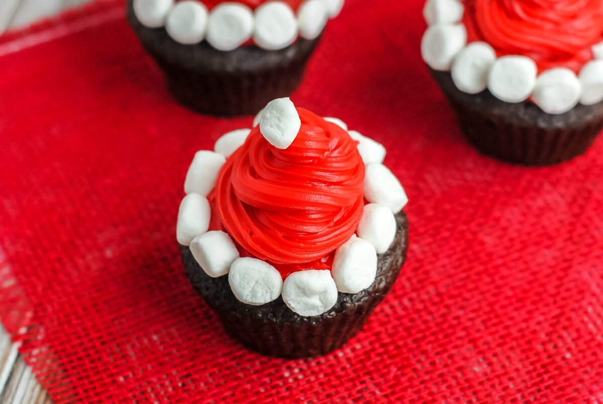 These Santa hat cupcakes are easy to make, cute as can be and sure to please the kids. A fun holiday treat for Christmas!