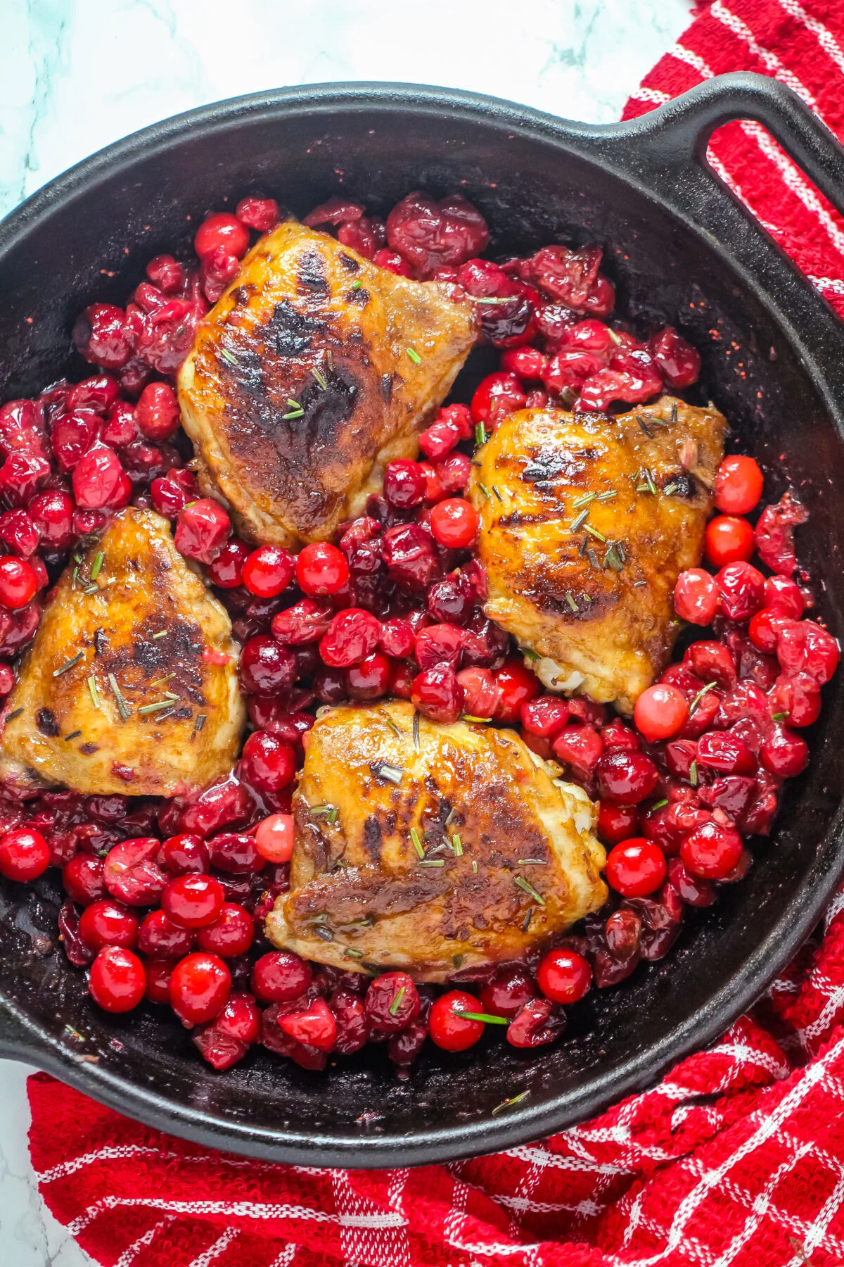 This Cranberry Roasted Chicken recipe is easy to make plus it's a one pan dinner that is oh so deliciously festive and seasonal.