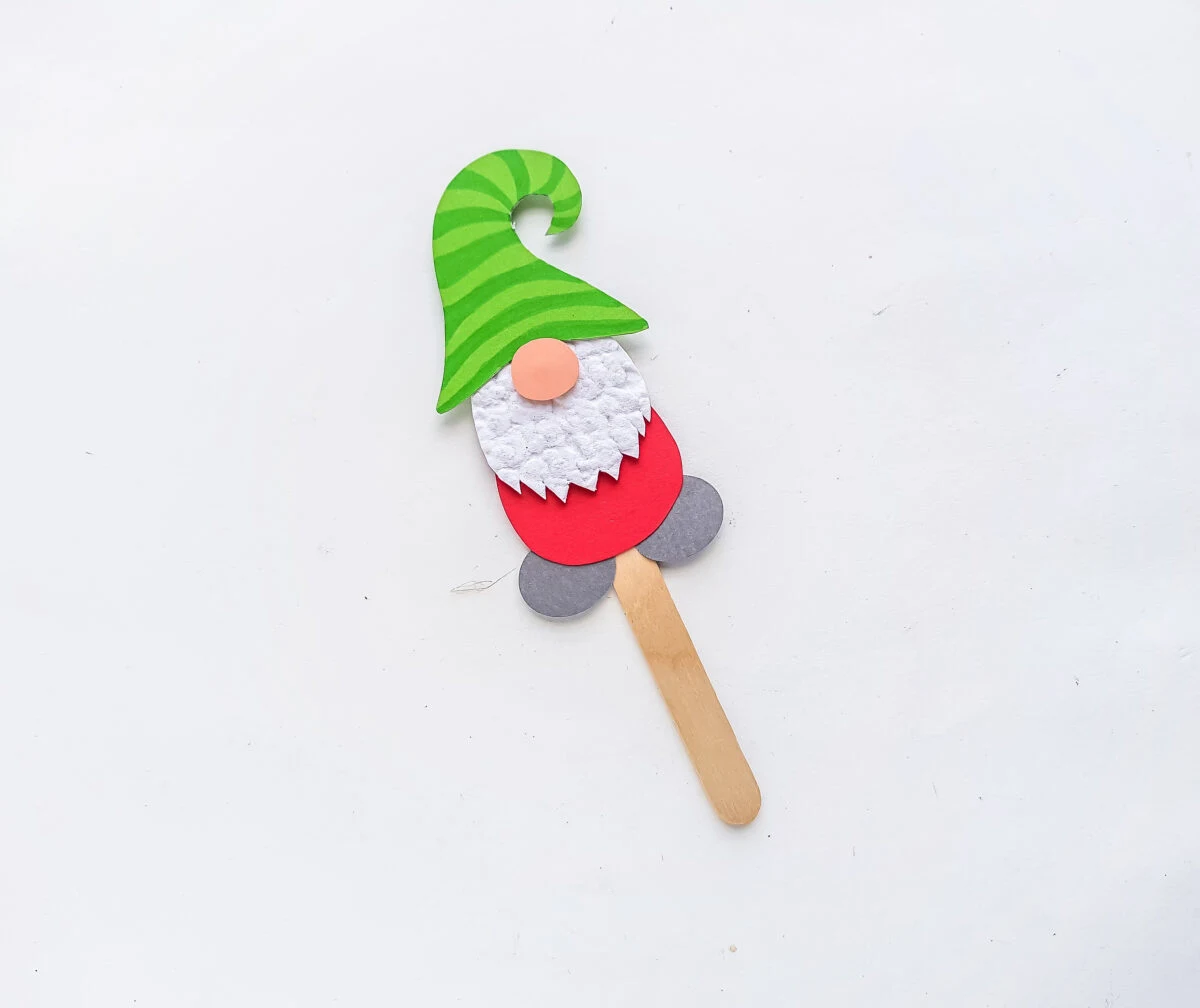 Attach the papercraft gnome on a popsicle stick to complete the puppet craft. 