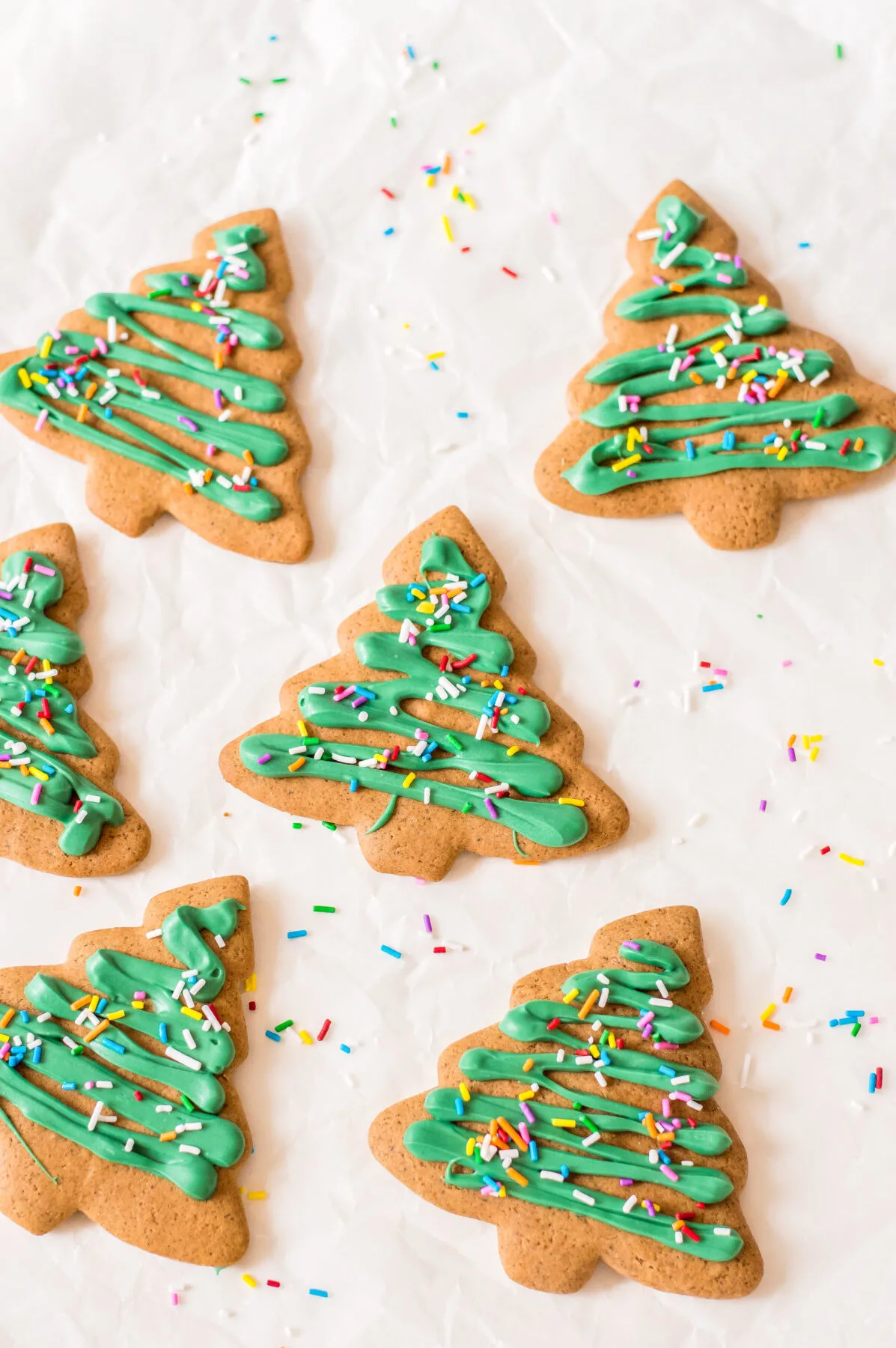 These gingerbread Christmas tree cookies are fun to make with your family. They're festive, delicious, and perfect for any holiday party!