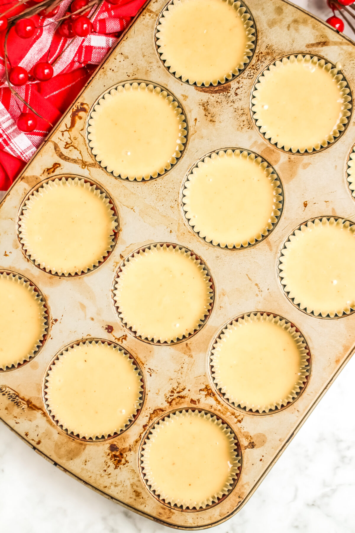 Muffin tins filled with cupcake batter.