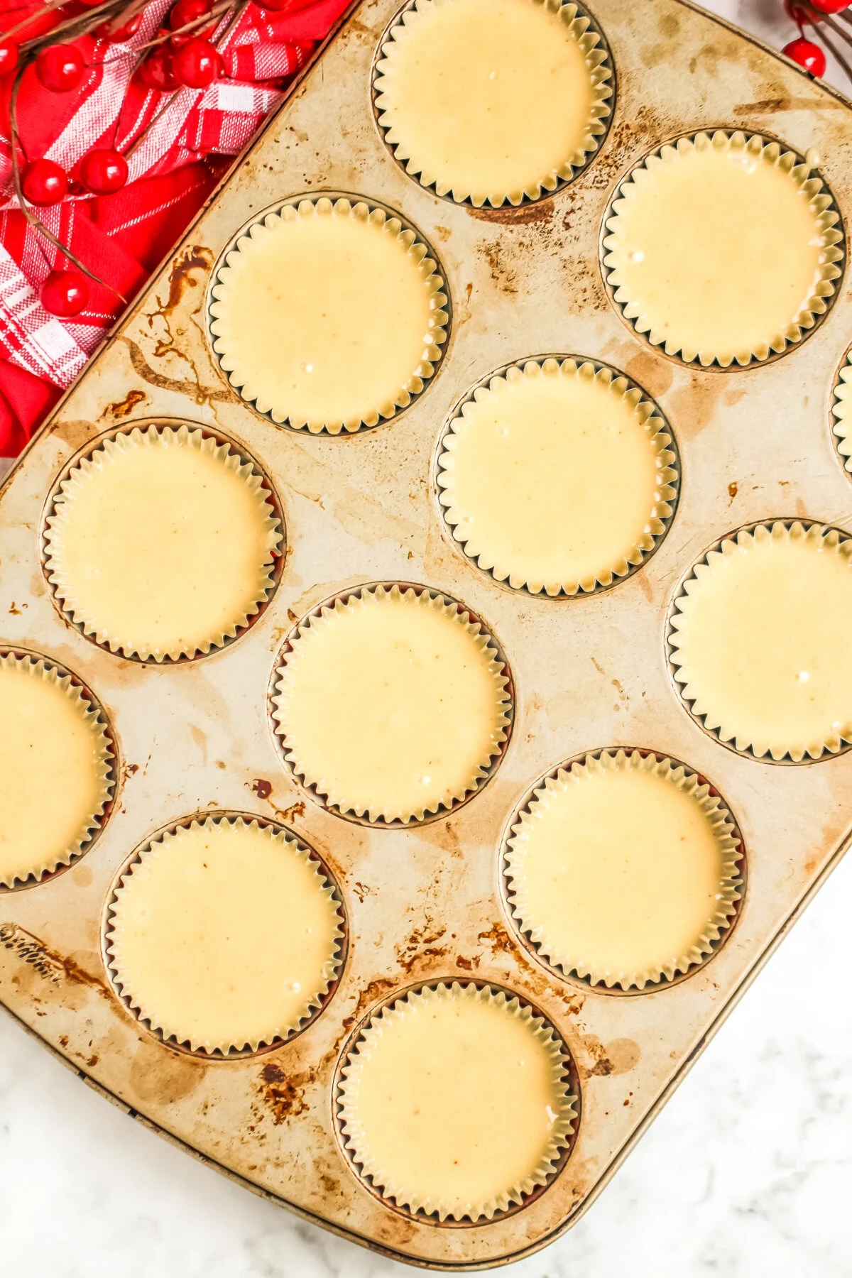Muffin tins filled with cupcake batter.