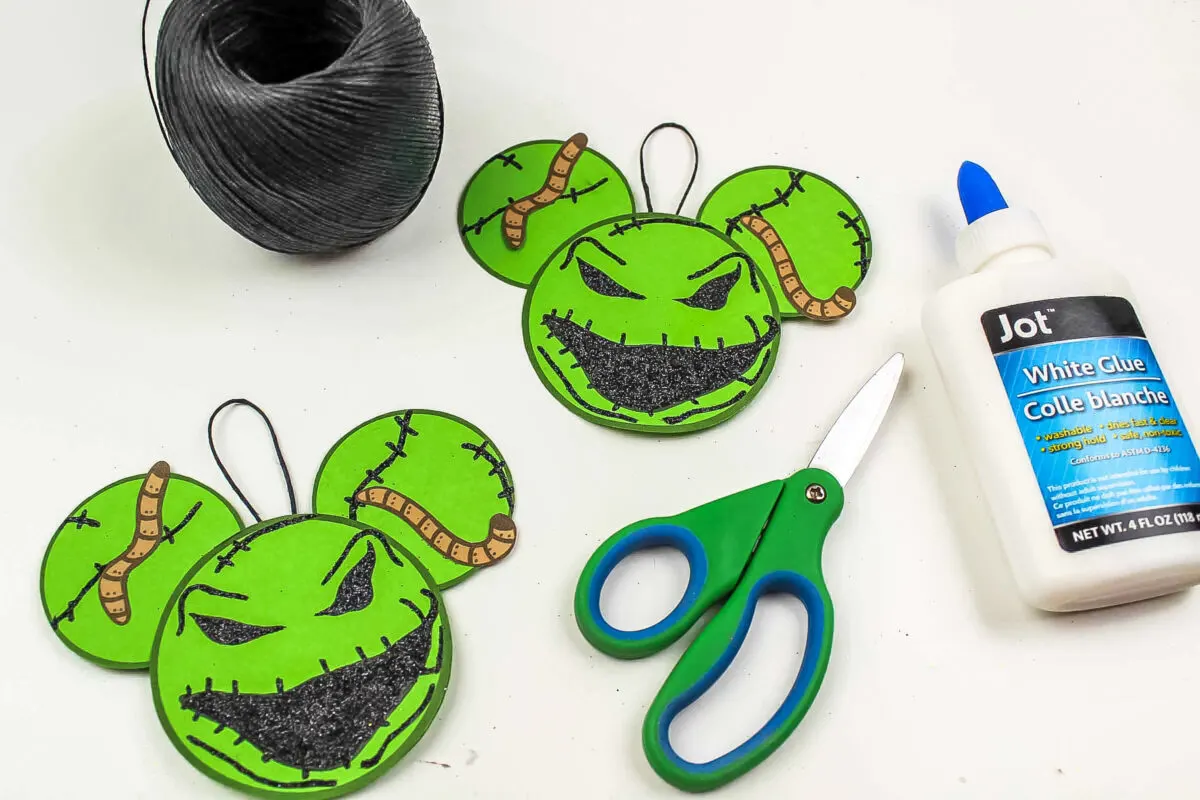 Loops being glued onto the back of the oogie boogie ornaments.