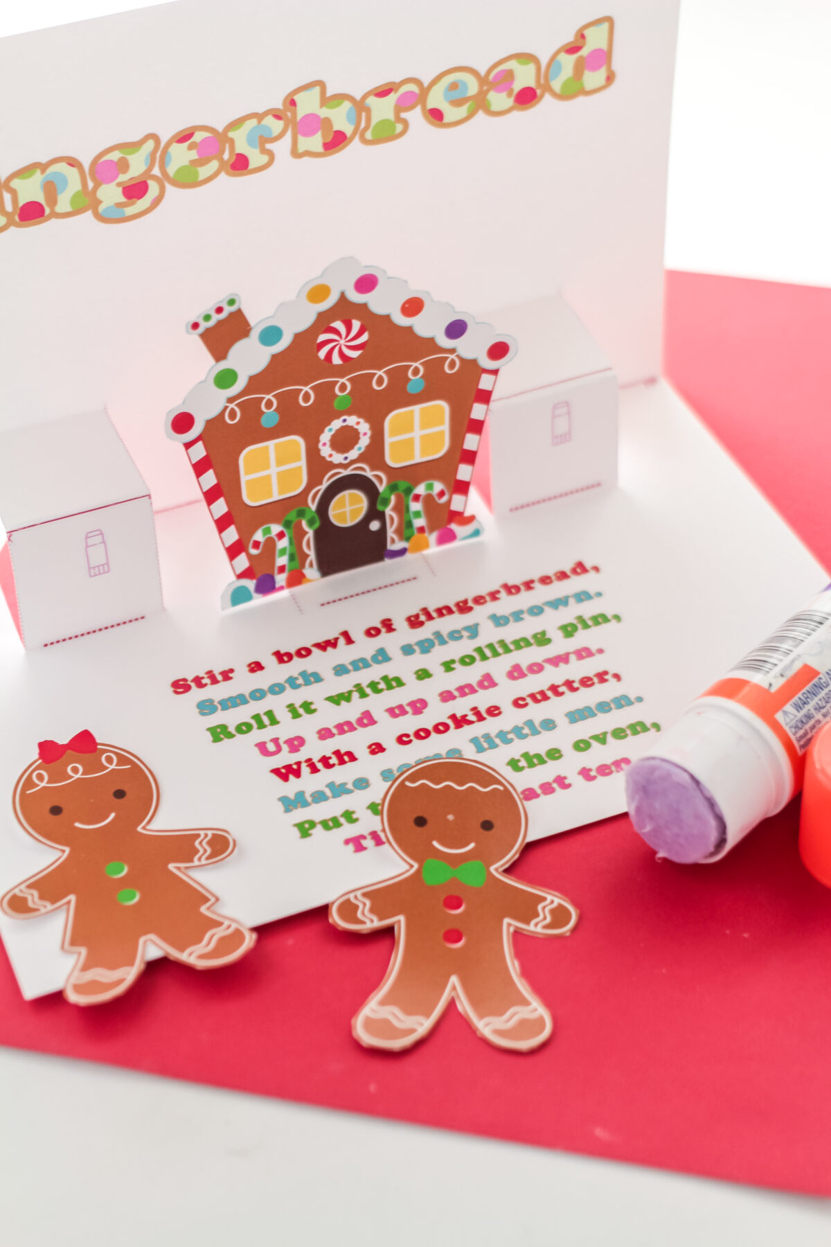 Gluing the gingerbread cookies cut outs onto the card,