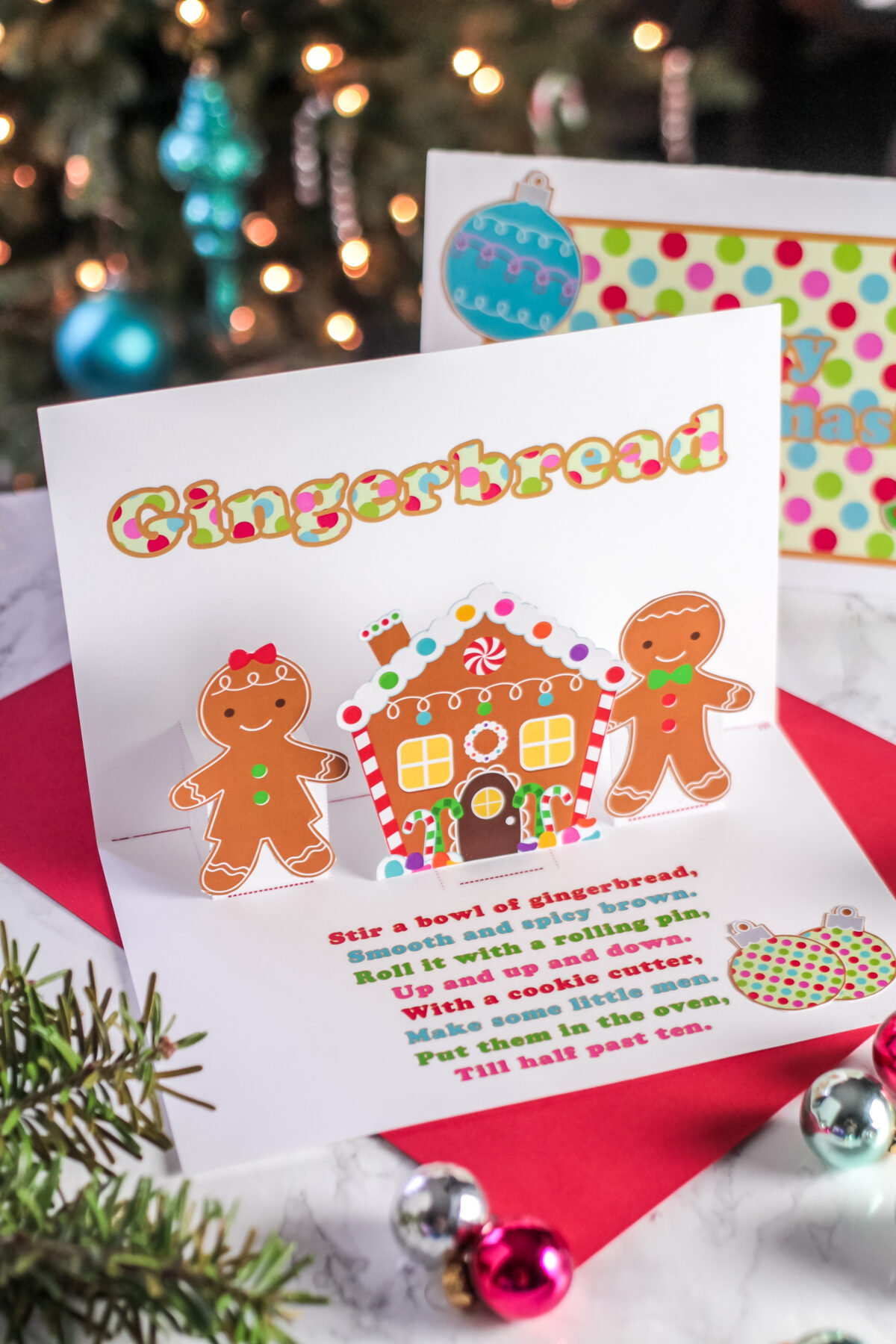 A free printable holiday card with a gingerbread pop up design. Download the pop up Christmas card template, cut and fold to make your own!
