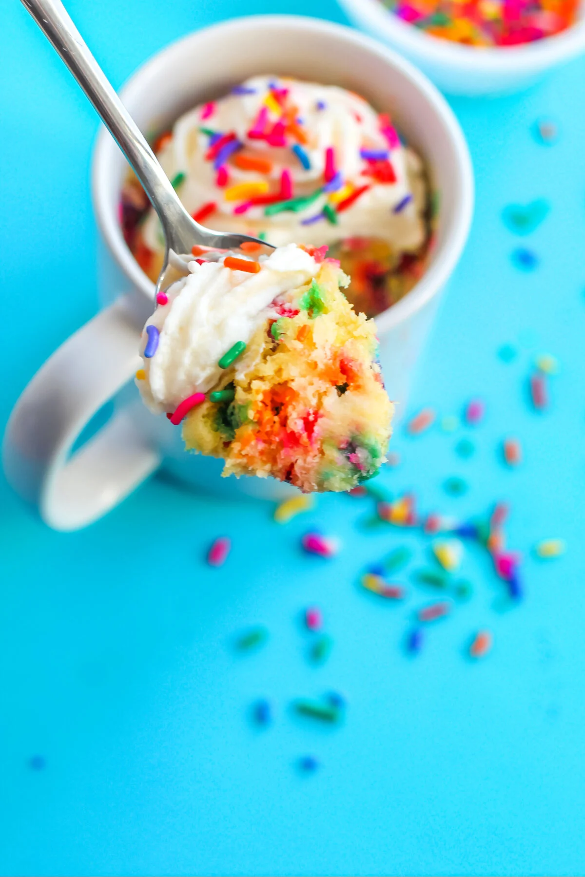 Make a funfetti mug cake that's moist, fluffy, and full of sprinkles. This single-serve cake recipe is easy to whip up in the microwave!