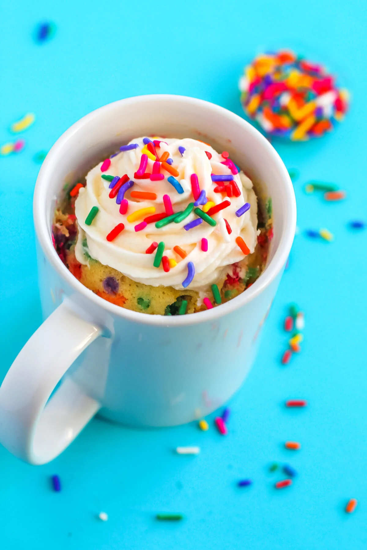 Make a funfetti mug cake that's moist, fluffy, and full of sprinkles. This single-serve cake recipe is easy to whip up in the microwave!