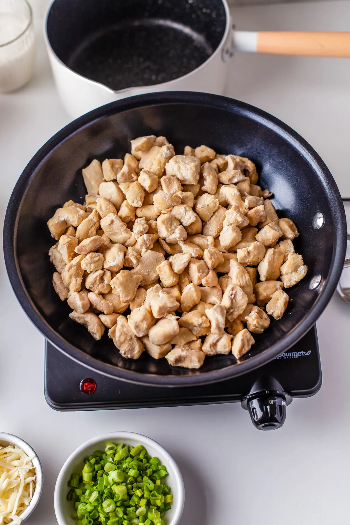 Chicken cooking in a skillet