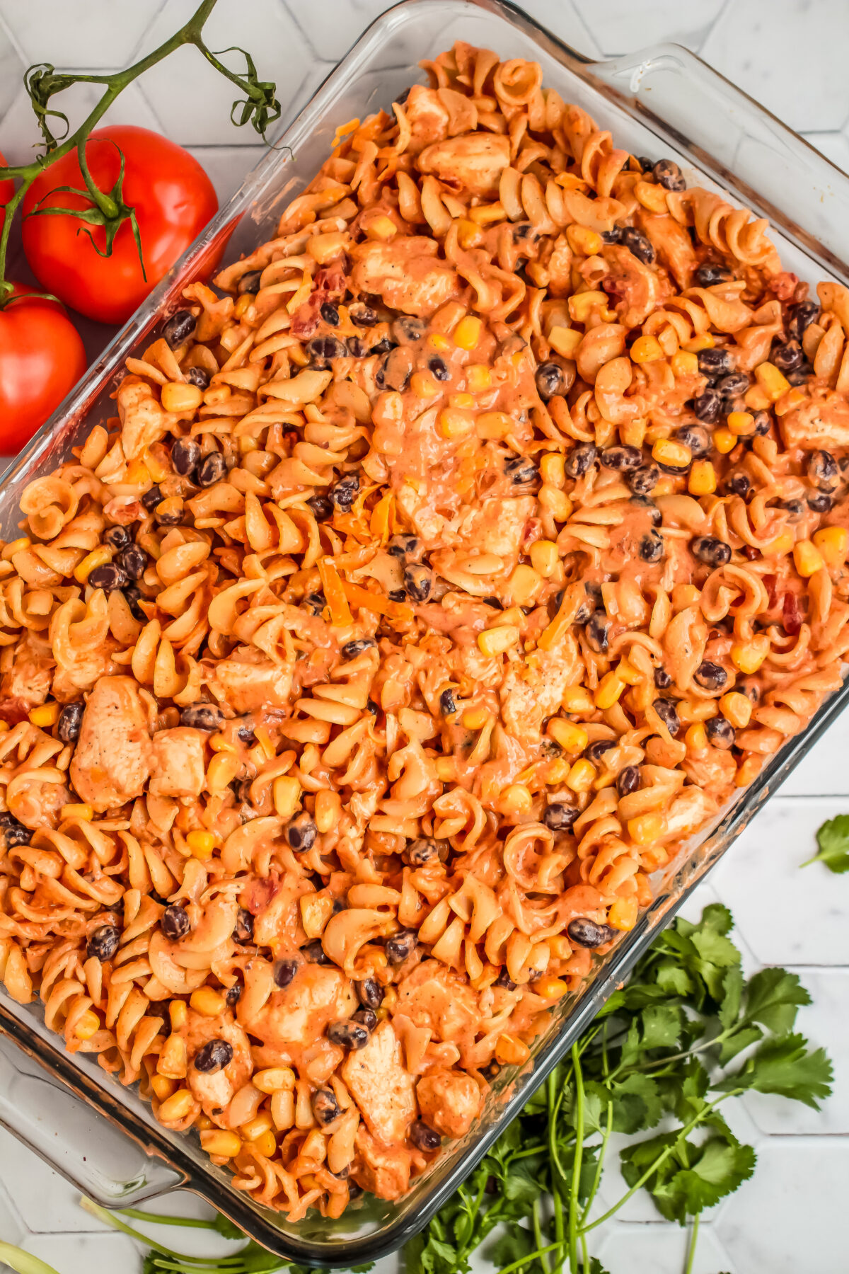 Pasta and chicken mixture poured into a casserole dish.