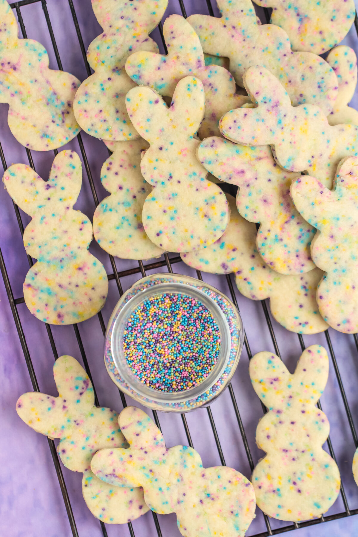 Delicious chocolate dipped Easter bunny sugar cookies complete with sprinkles that are the perfect addition to your Easter dessert table.