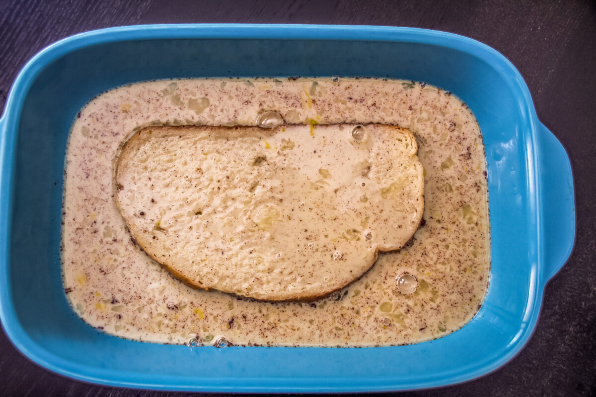 Bread dipped into the custard in a baking dish.