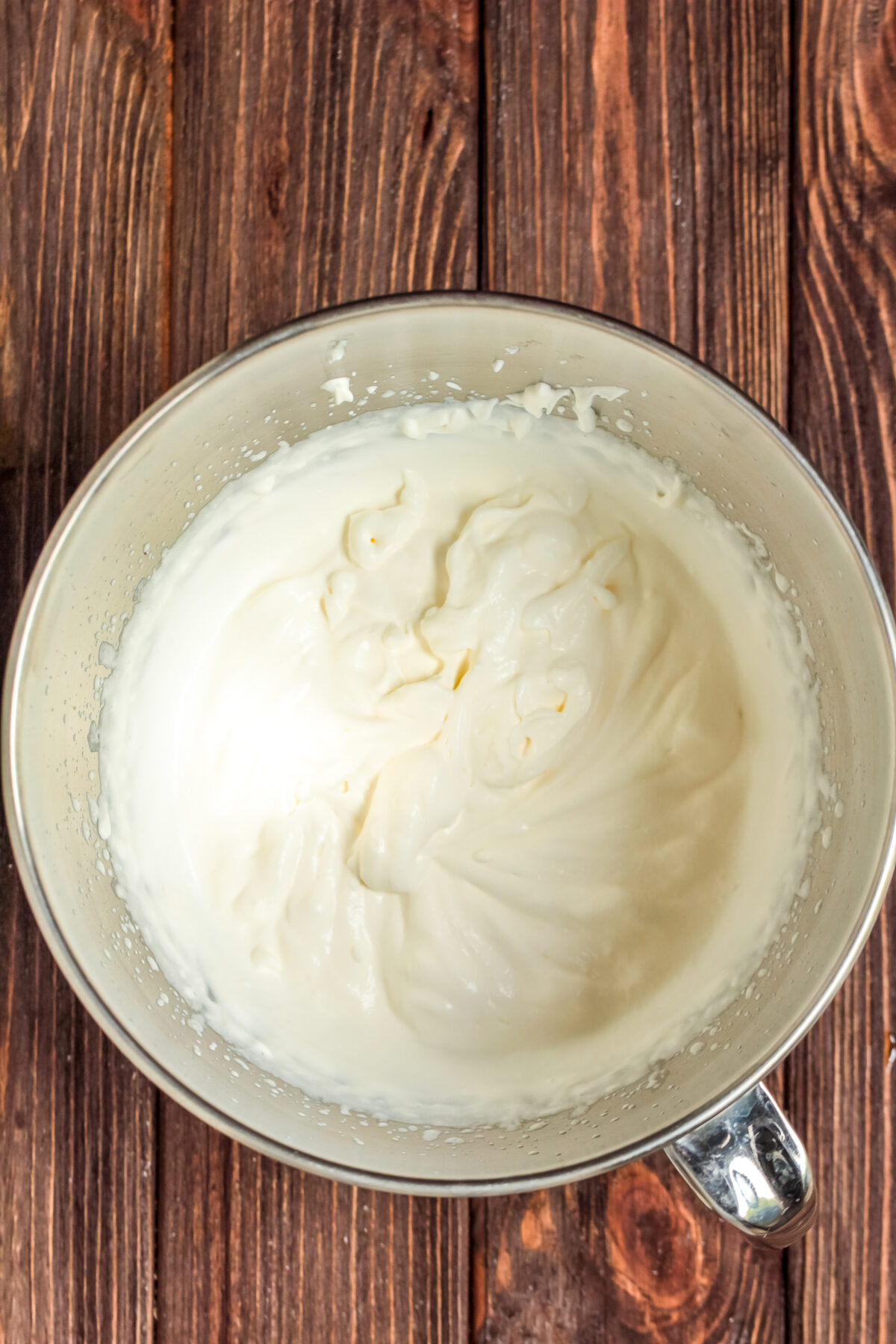 Whipping cream in a stand mixer bowl