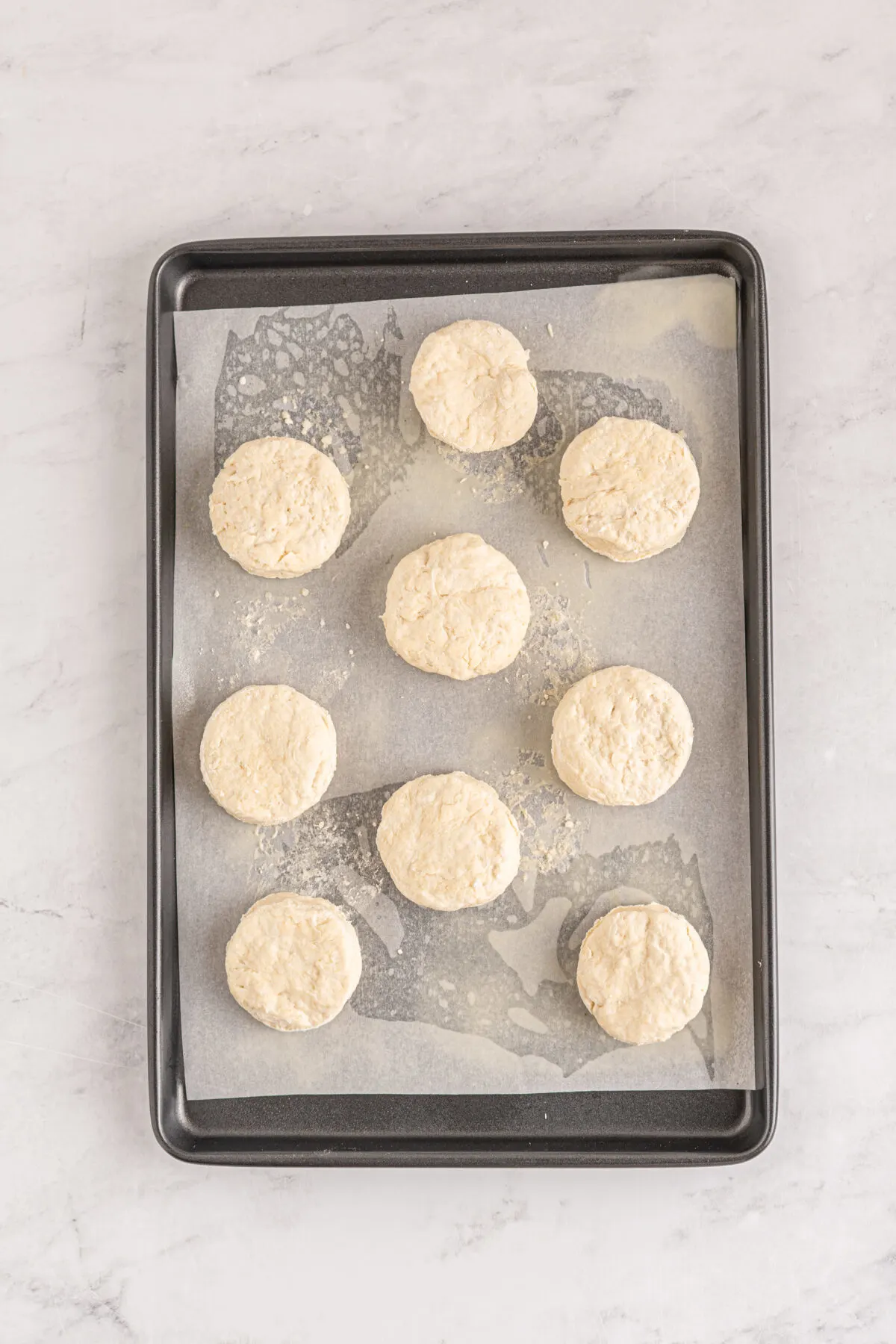 Unbaked biscuits on a baking sheet