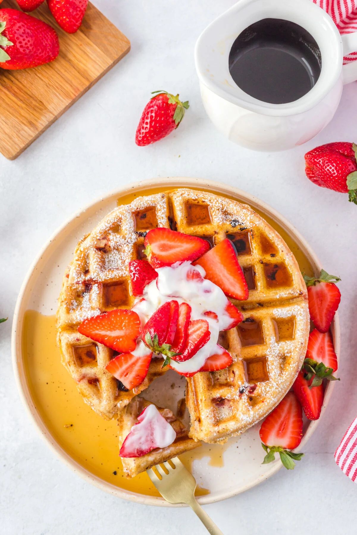 This recipe makes homemade strawberry waffles that are light, fluffy, and loaded with fresh strawberries. The perfect weekend breakfast treat!