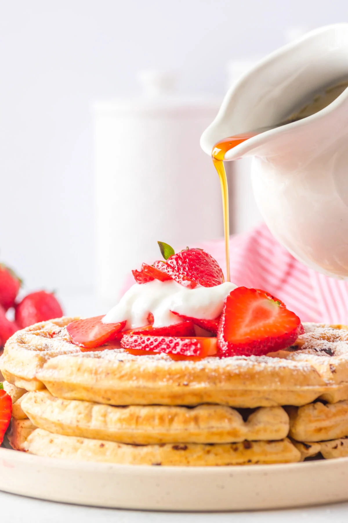 This recipe makes homemade strawberry waffles that are light, fluffy, and loaded with fresh strawberries. The perfect weekend breakfast treat!
