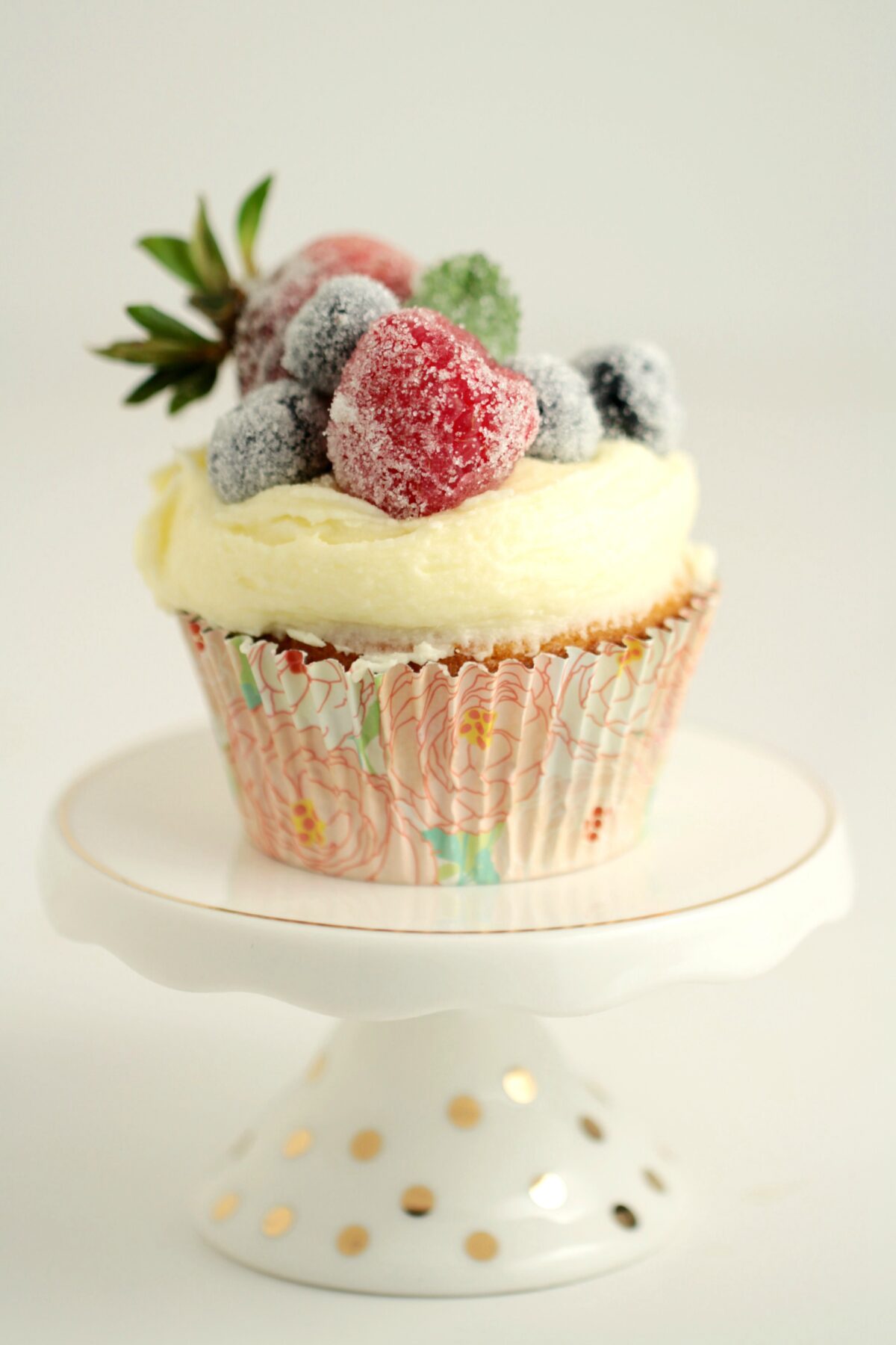 Frosted Berry Cupcakes with an Orange Mascarpone Buttercream feature a fluffy orange cake topped with a luscious frosting, and sugared fruit.