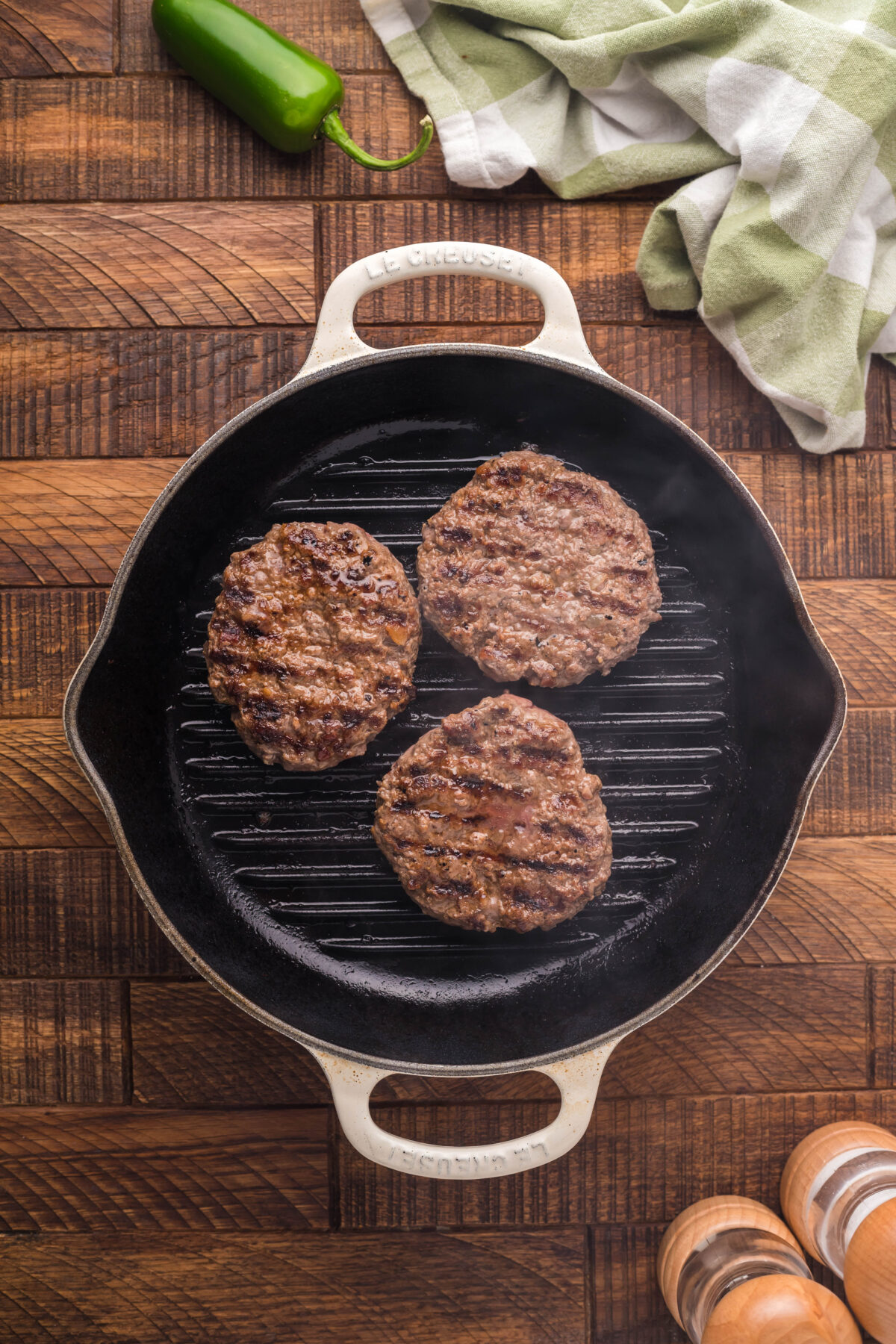 Cooked burger patties in a grill pan.