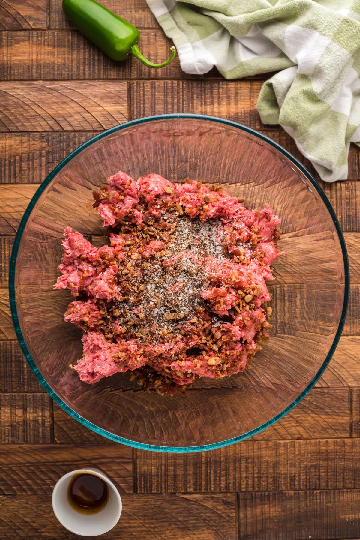 Ground beef and seasonings in a bowl.