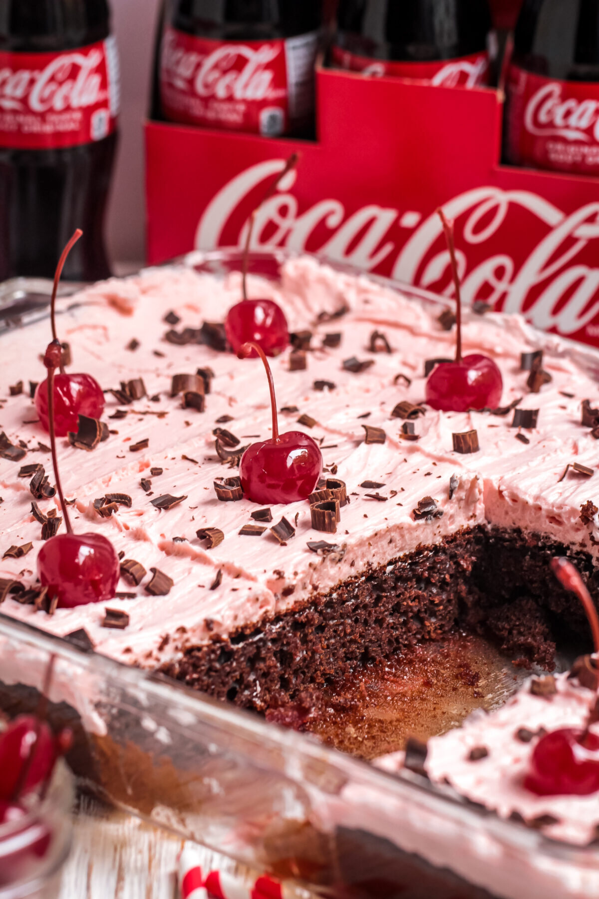 This easy chocolate cherry coke cake recipe is made with coca cola, cake mix, and maraschino cherries. You will love how moist this cake is.