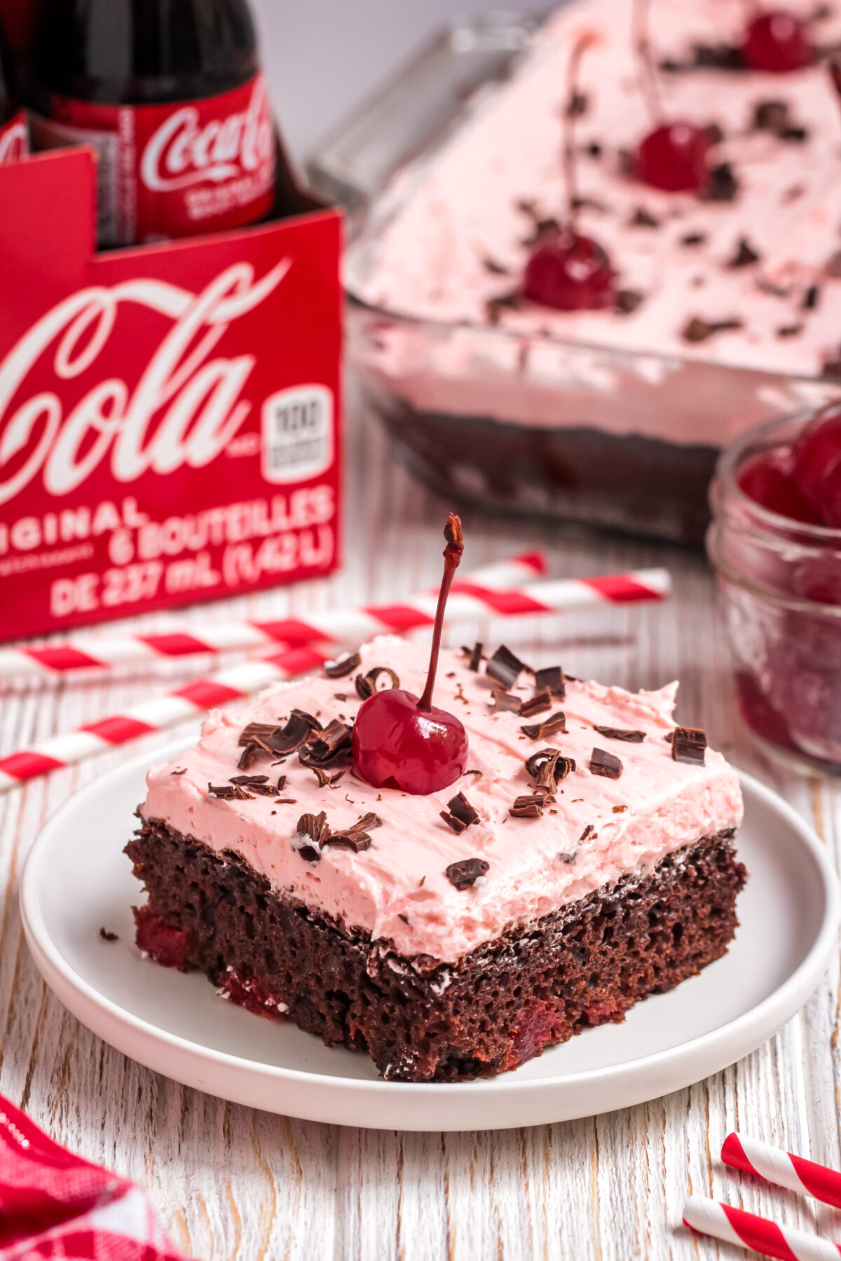 This easy chocolate cherry coke cake recipe is made with coca cola, cake mix, and maraschino cherries. You will love how moist this cake is.