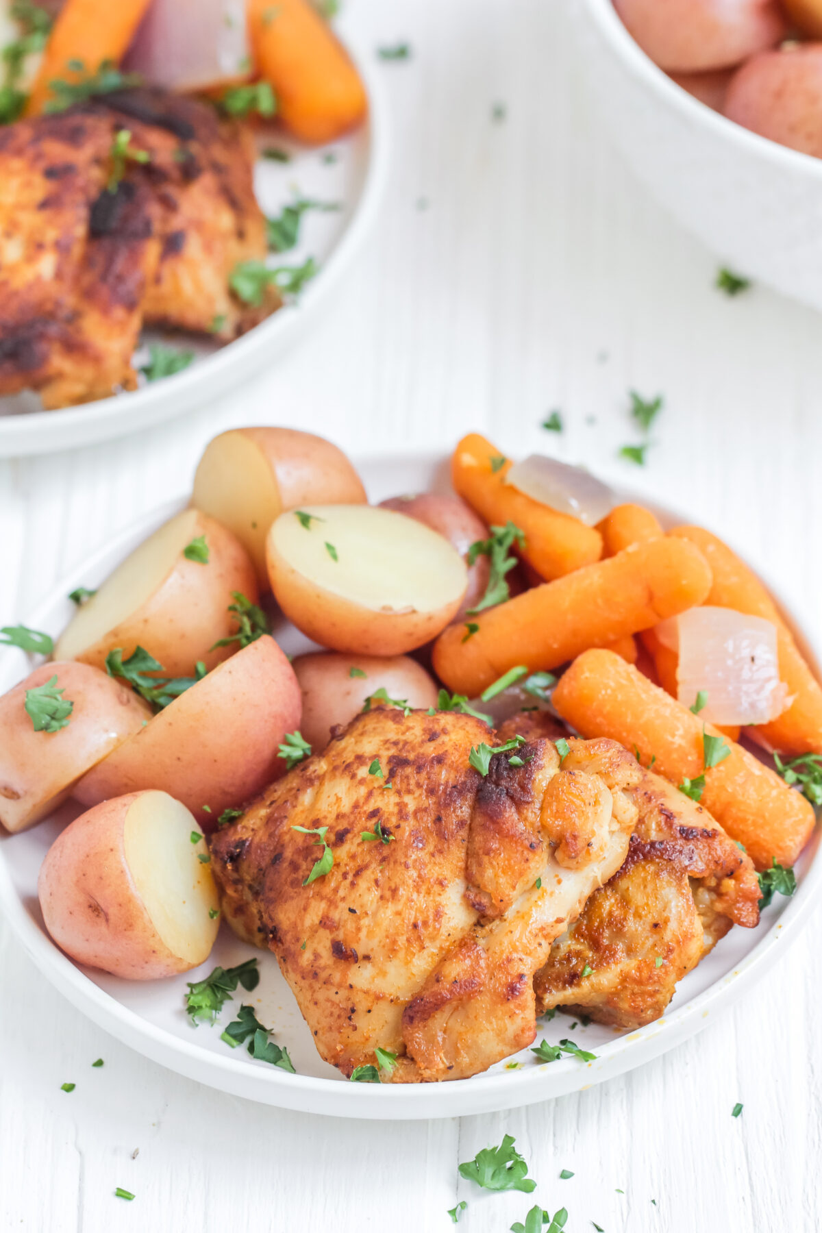 This easy slow cooker chicken thighs and potatoes recipe is perfect for a busy family. With carrots, it's a crock pot meal that's complete!