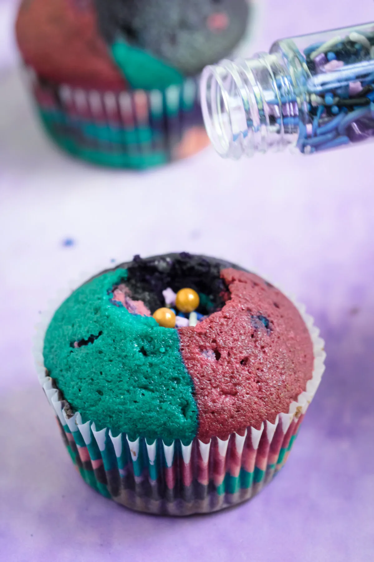 Filling the cupcake with sprinkles.