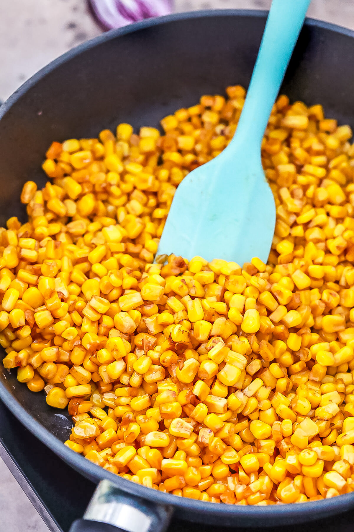 Roasting corn in a pan.