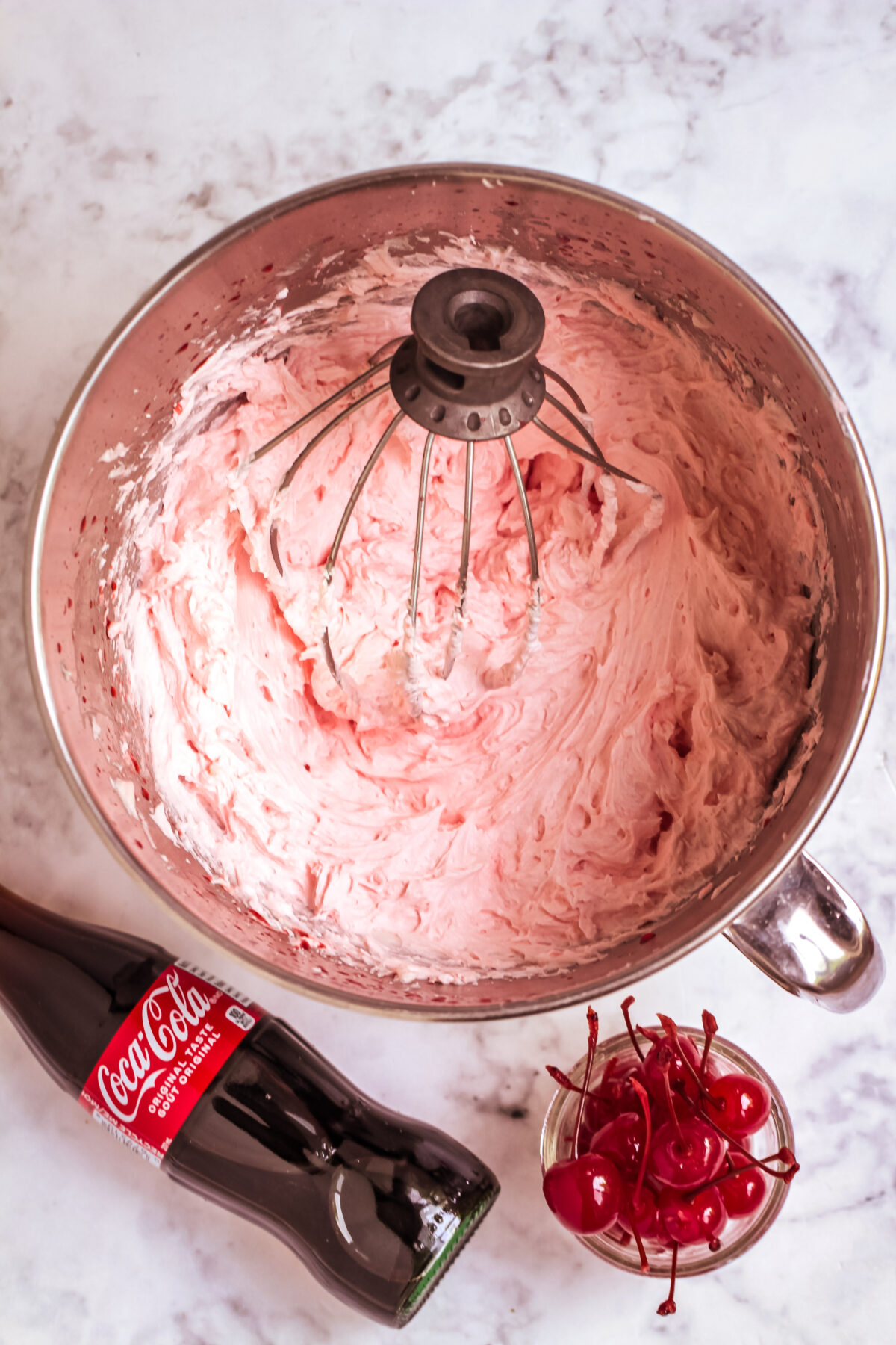 Cherry buttercream in a stand mixer bowl.