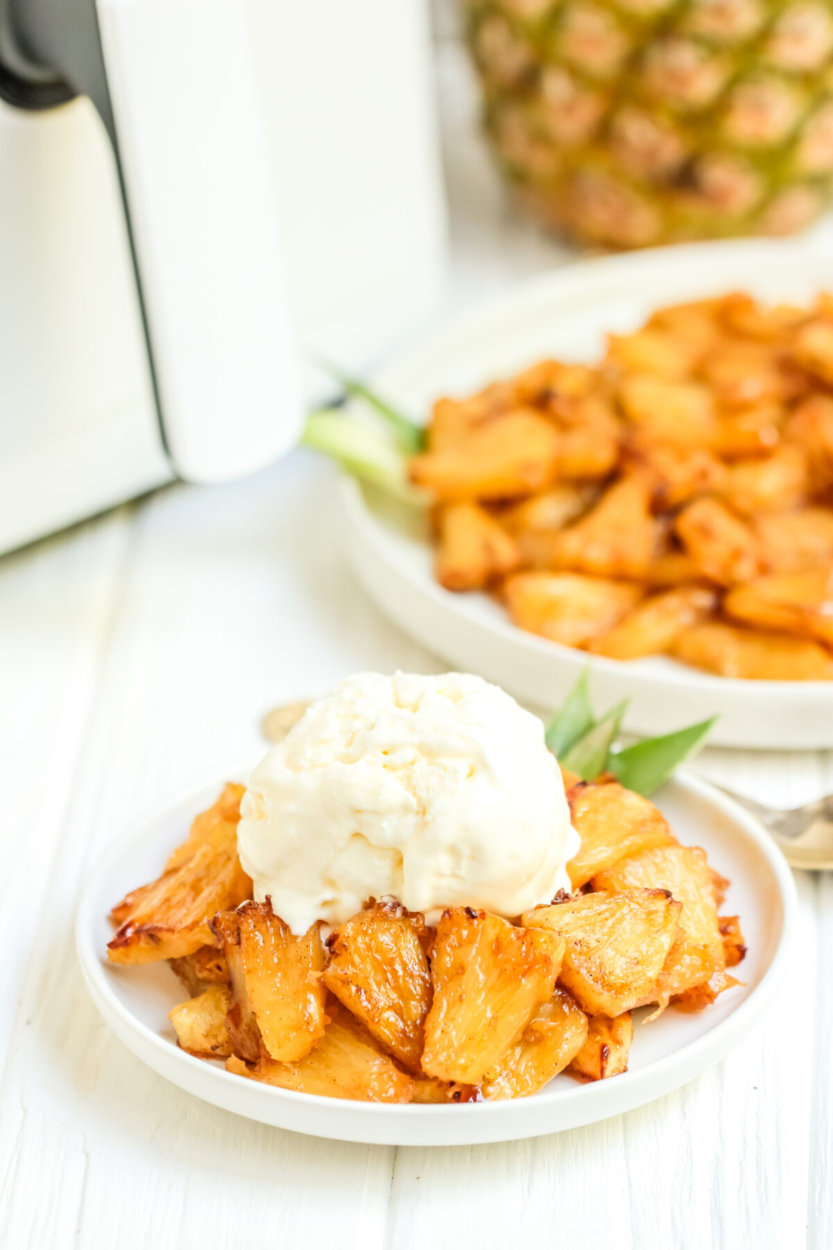 Easy air fryer pineapple recipe. Serve with a scoop of vanilla ice cream for dessert, this pineapple is perfectly caramelized and sweet!