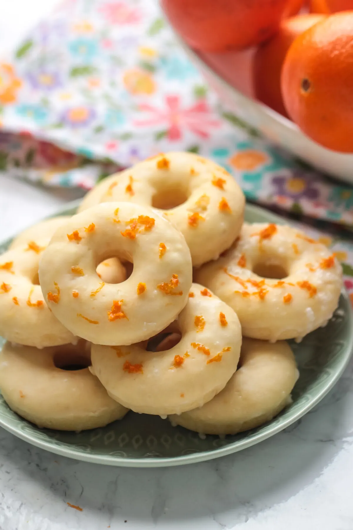 Love homemade donuts? Check out this delicious and easy to follow recipe for orange glazed cake donuts! They can be baked or fried!